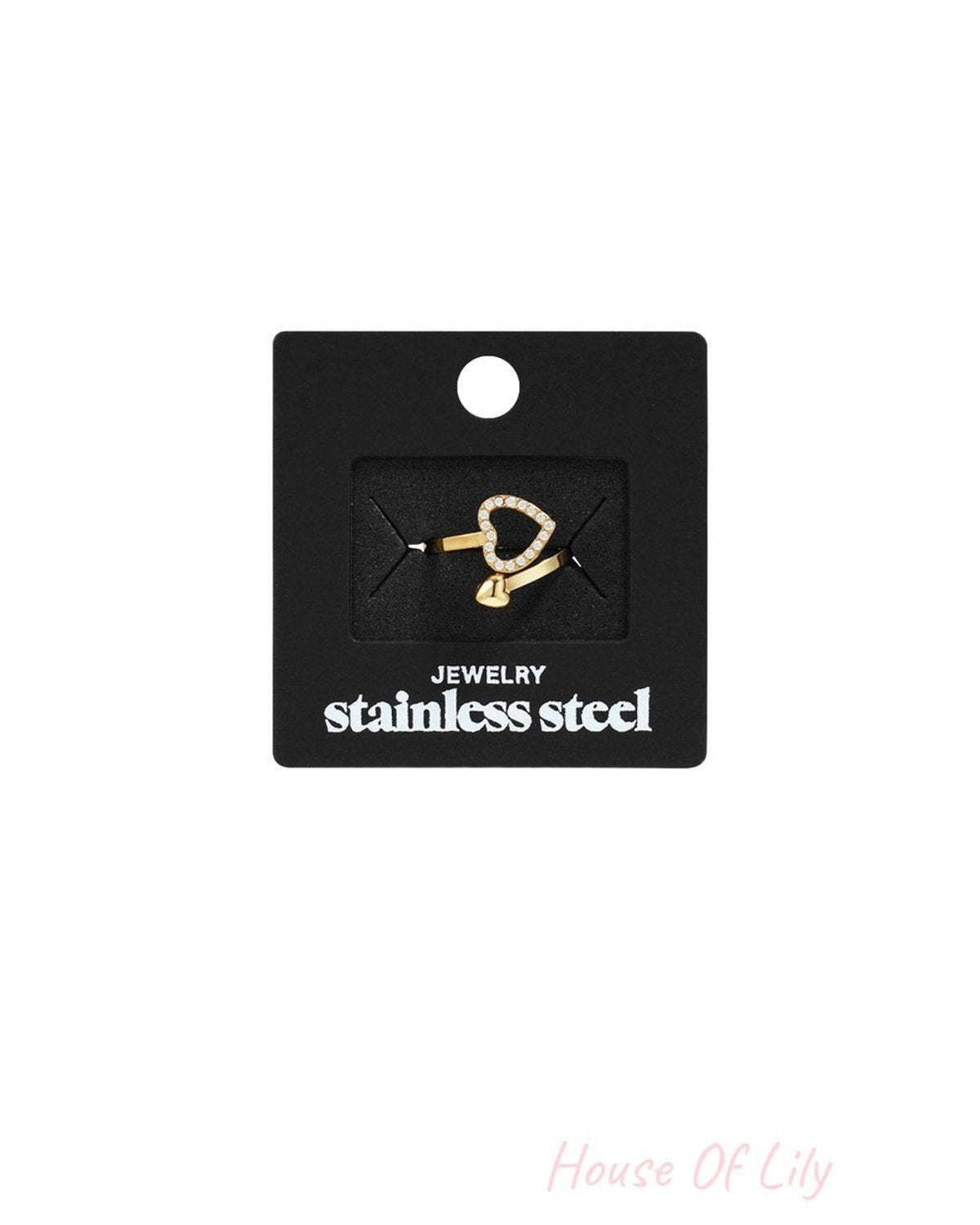 Gold-tone stainless steel ring featuring a pavé heart design on a slender, open-ended band on a black jewelry card.
