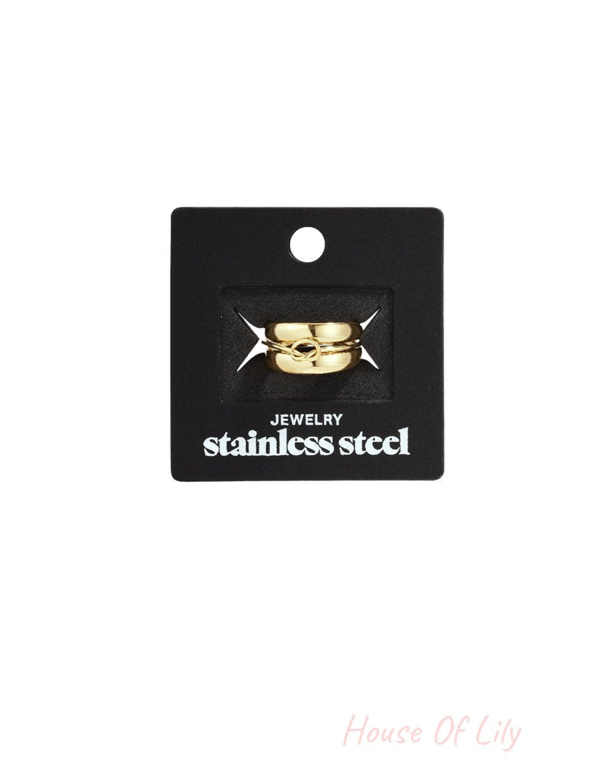Wavy Gravy gold-toned stainless steel ring featuring a delicate, knotted center detail on a black display card.