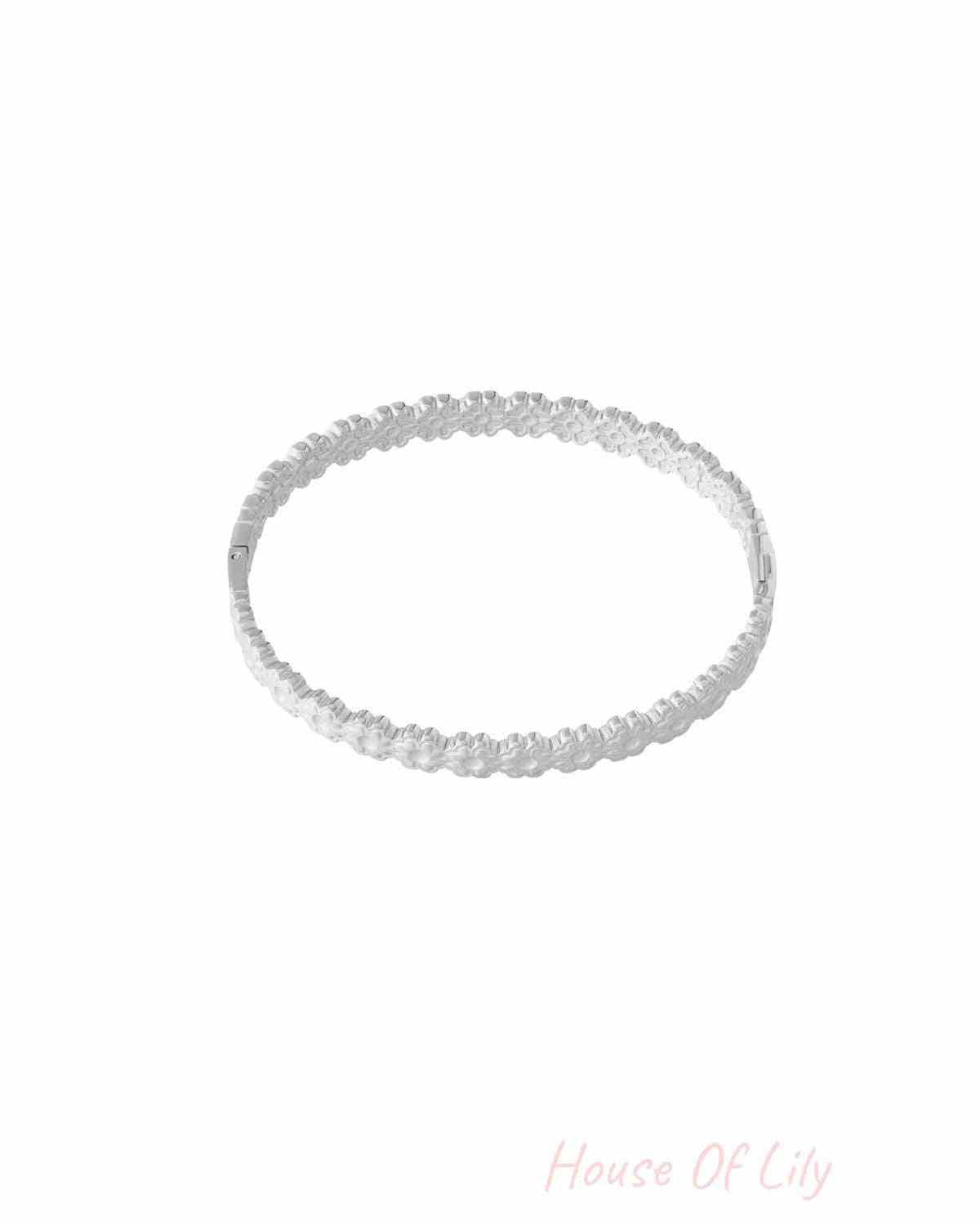 Silver floral detail bangle bracelet with delicate flower pattern