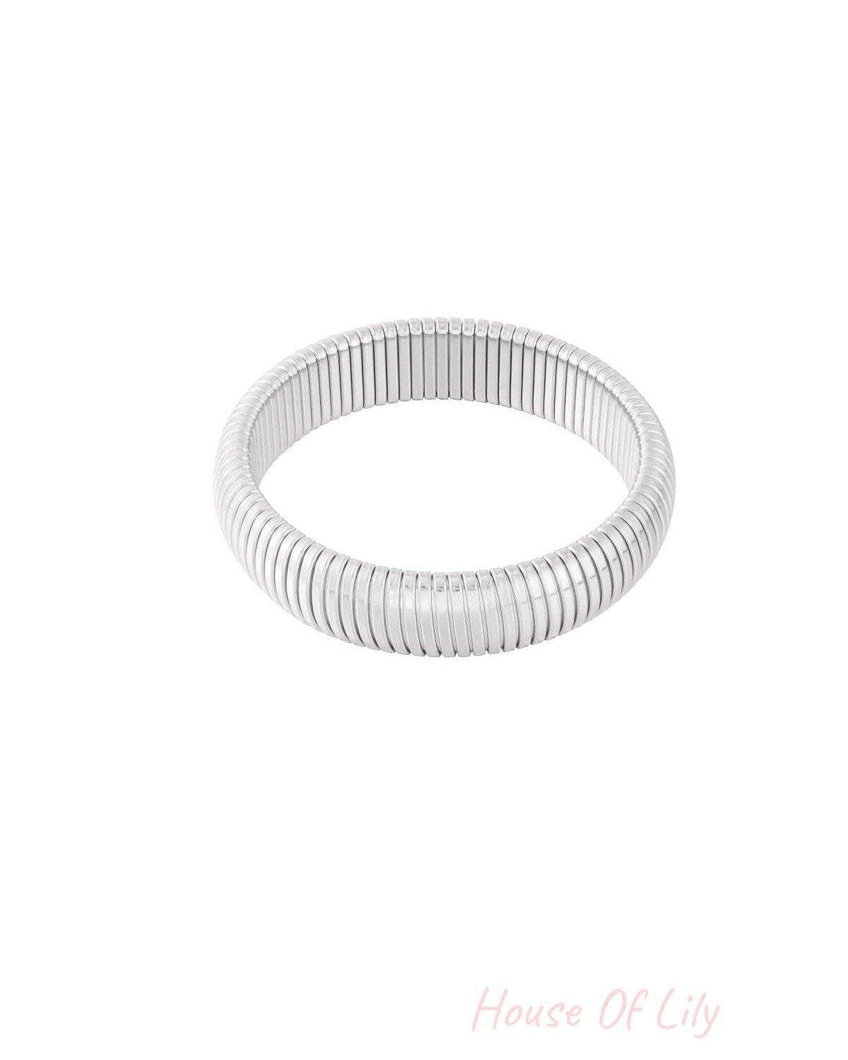 Side view of the gold stretch bracelet highlighting smooth segmented design and polish