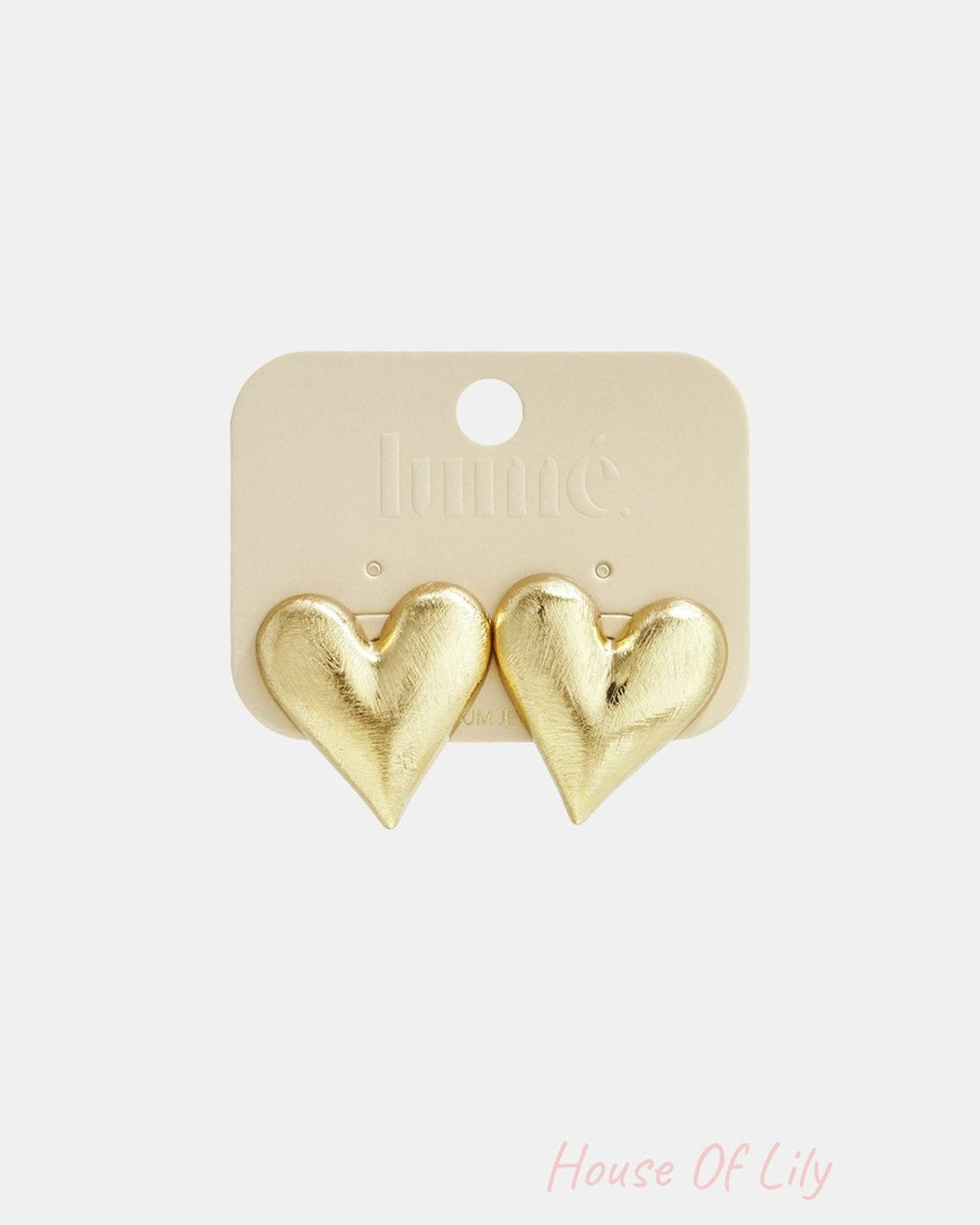 Puffy Crush Studs: Brushed gold-tone metal earrings in a voluminous, puffy heart shape on a branded display card.