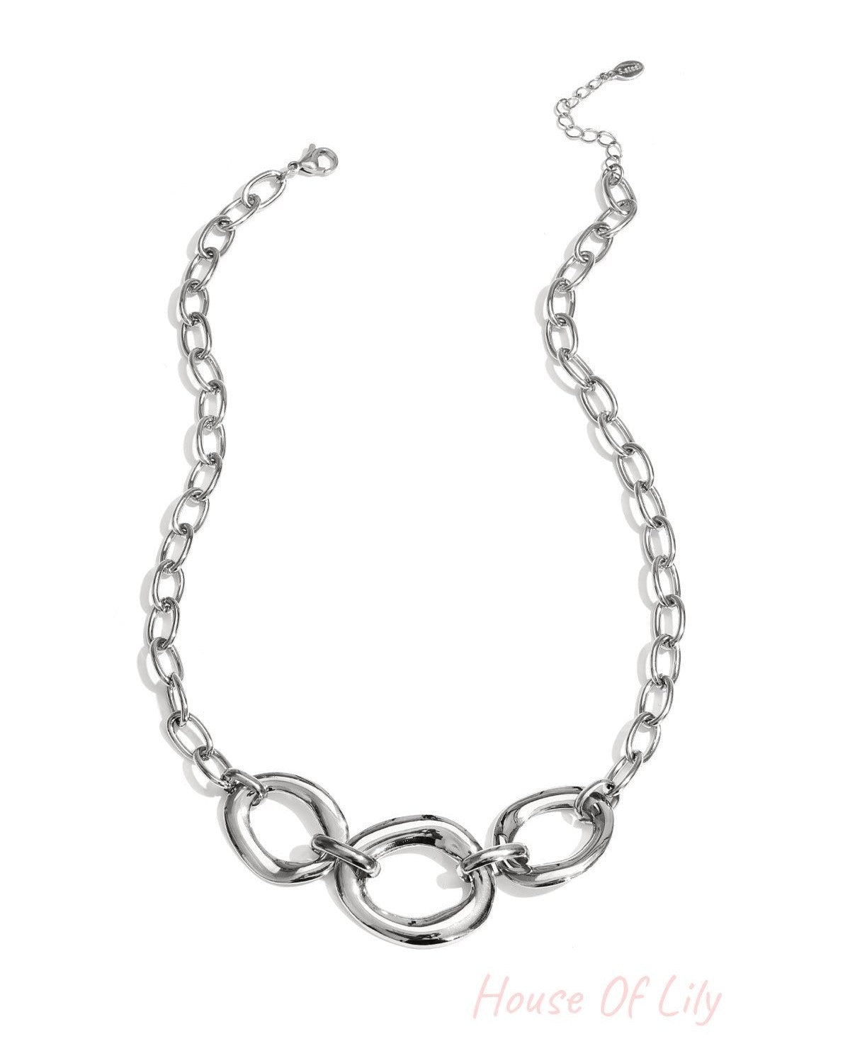 Silver chunky link necklace with three oversized rounded links and adjustable chain on white background