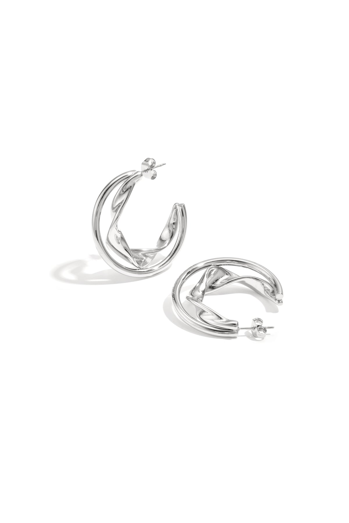 Silver twisted double hoop earrings displayed on white background
