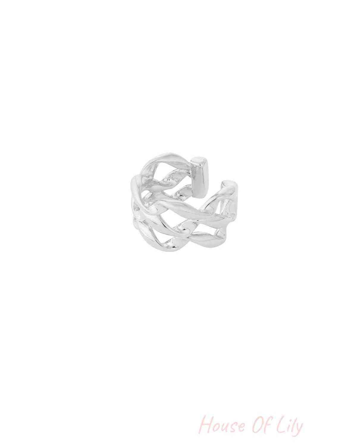 Close-up image of a shiny silver twisted chain ear cuff with an open adjustable design on a white background