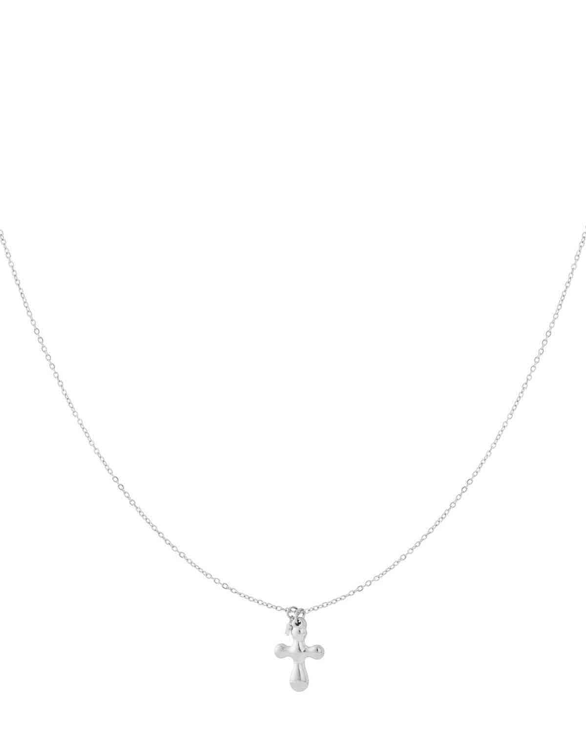 Minimal silver cross pendant necklace with thin chain on white background