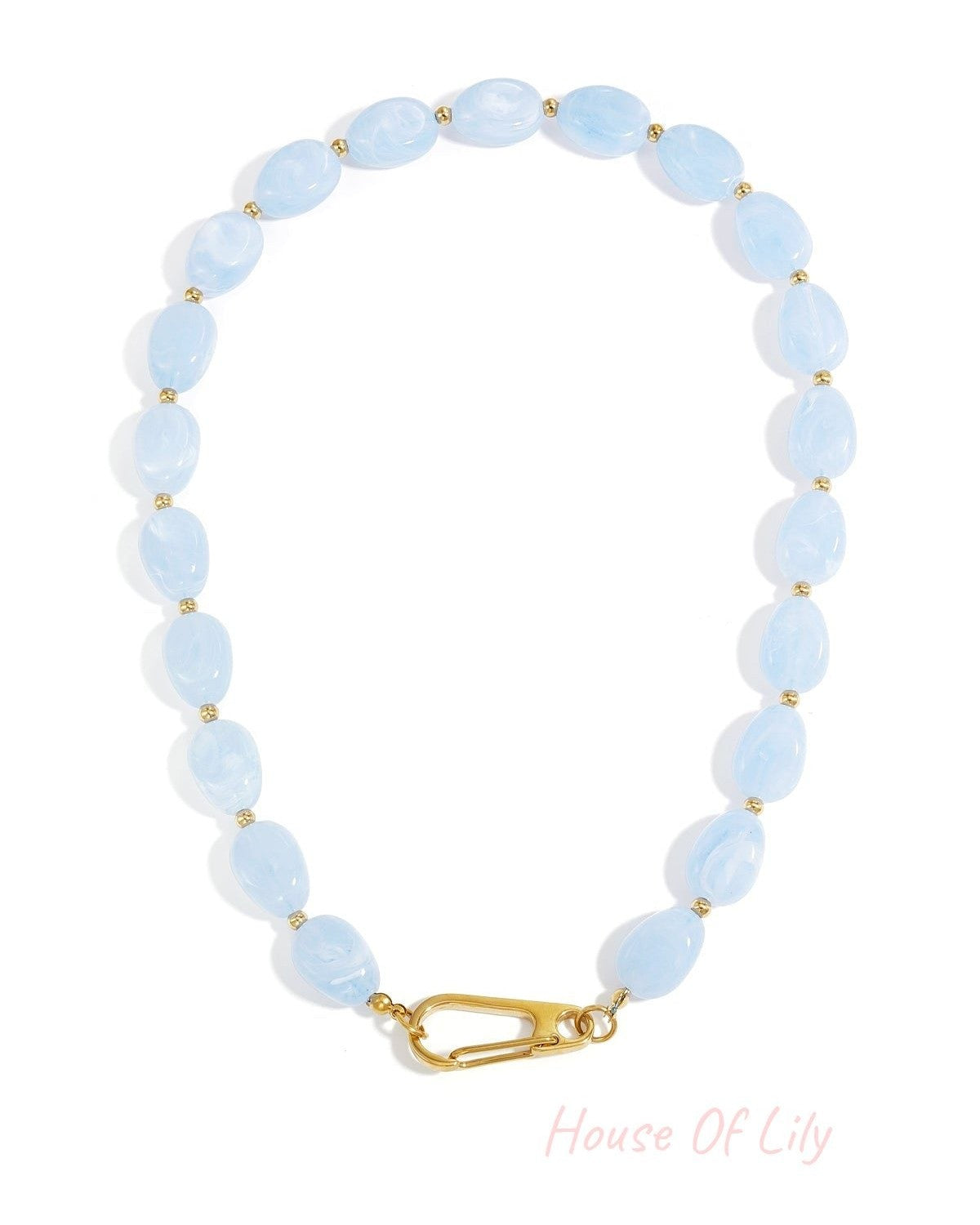 Baby blue acrylic beaded necklace with gold accents and clasp laid flat on white background