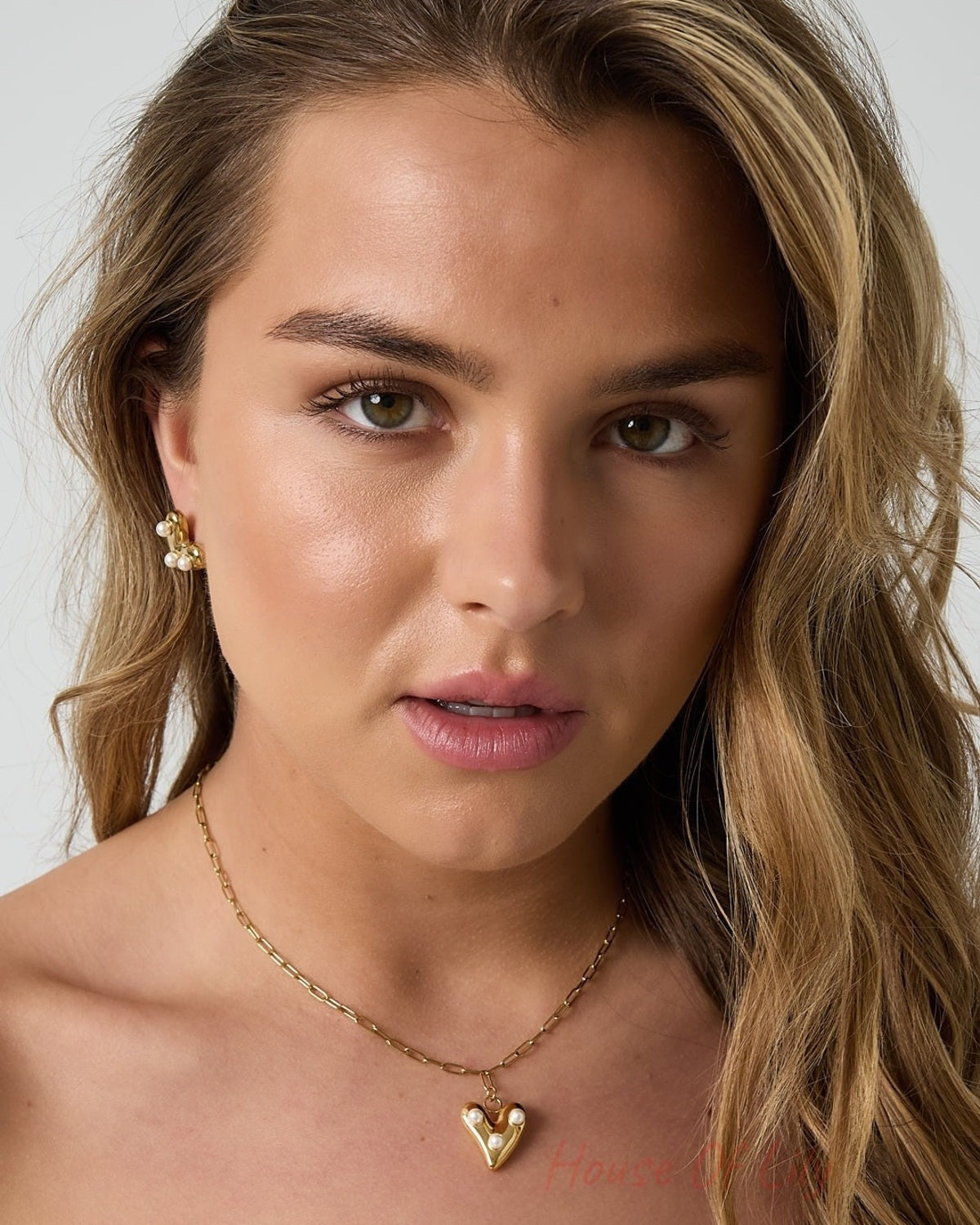 Model showcasing the pearl heart pendant necklace and earrings set, highlighting the youthful and soft jewelry style