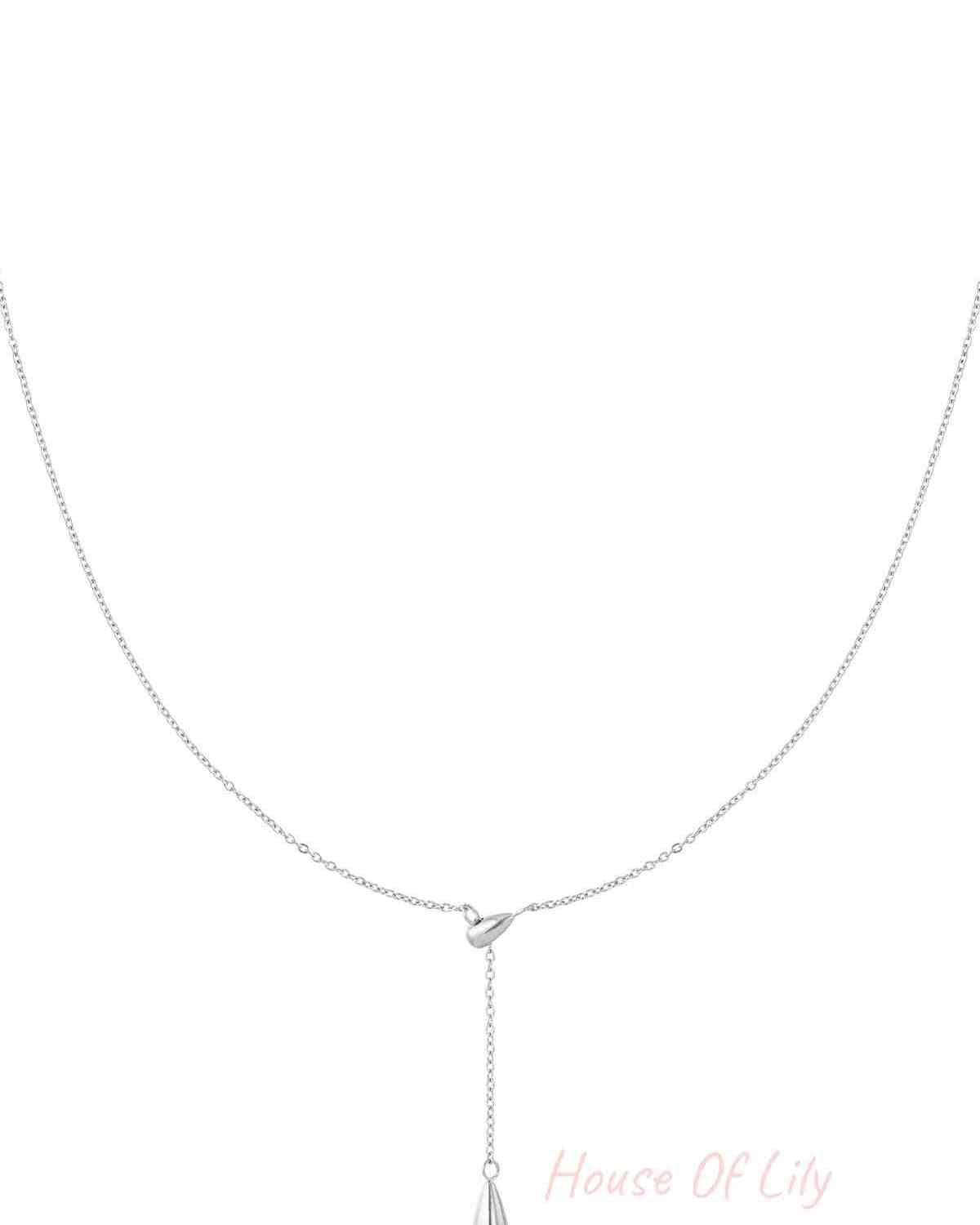 Minimalist silver drop charm necklace with fine chain against white background