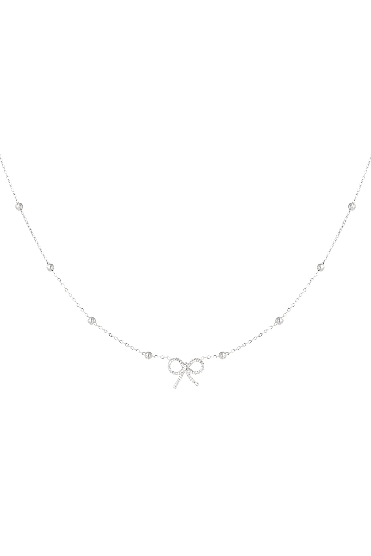 Detailed shot of a delicate silver bow pendant necklace with a fine chain and spaced bead accents