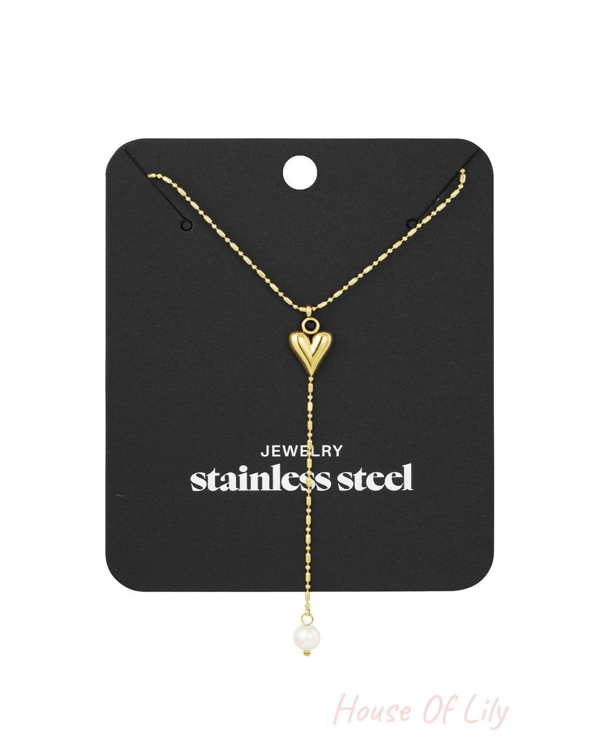 Jewellery display card showing gold-tone heart pendant necklace with pearl drop and stainless steel label