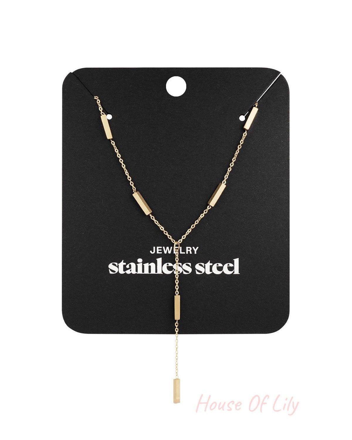 Gold-tone modern bar pendant necklace displayed on black packaging card with 'stainless steel' text