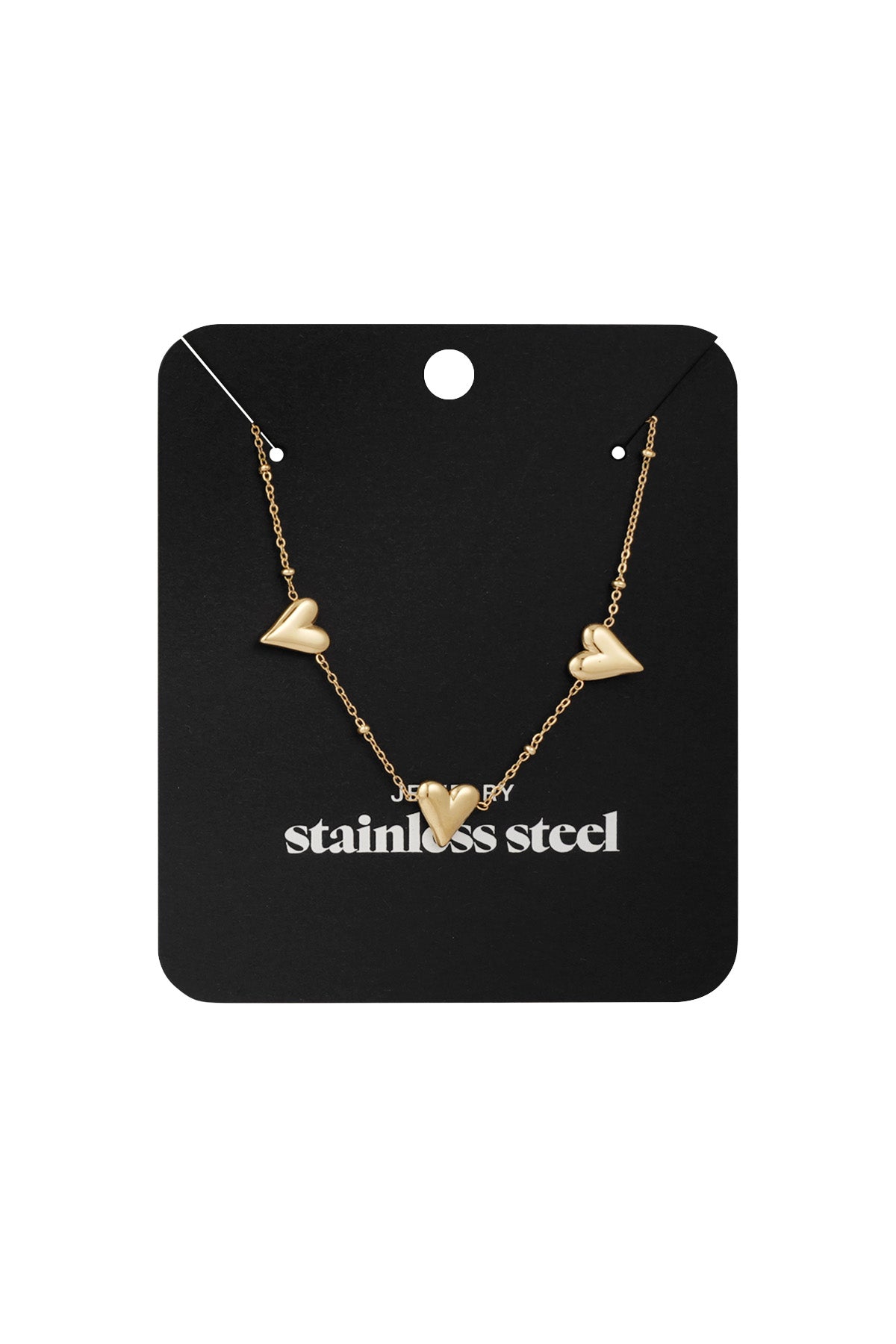 Triple heart gold-tone necklace displayed on a black jewelry card with 'stainless steel' printed, highlighting the product's packaging and material