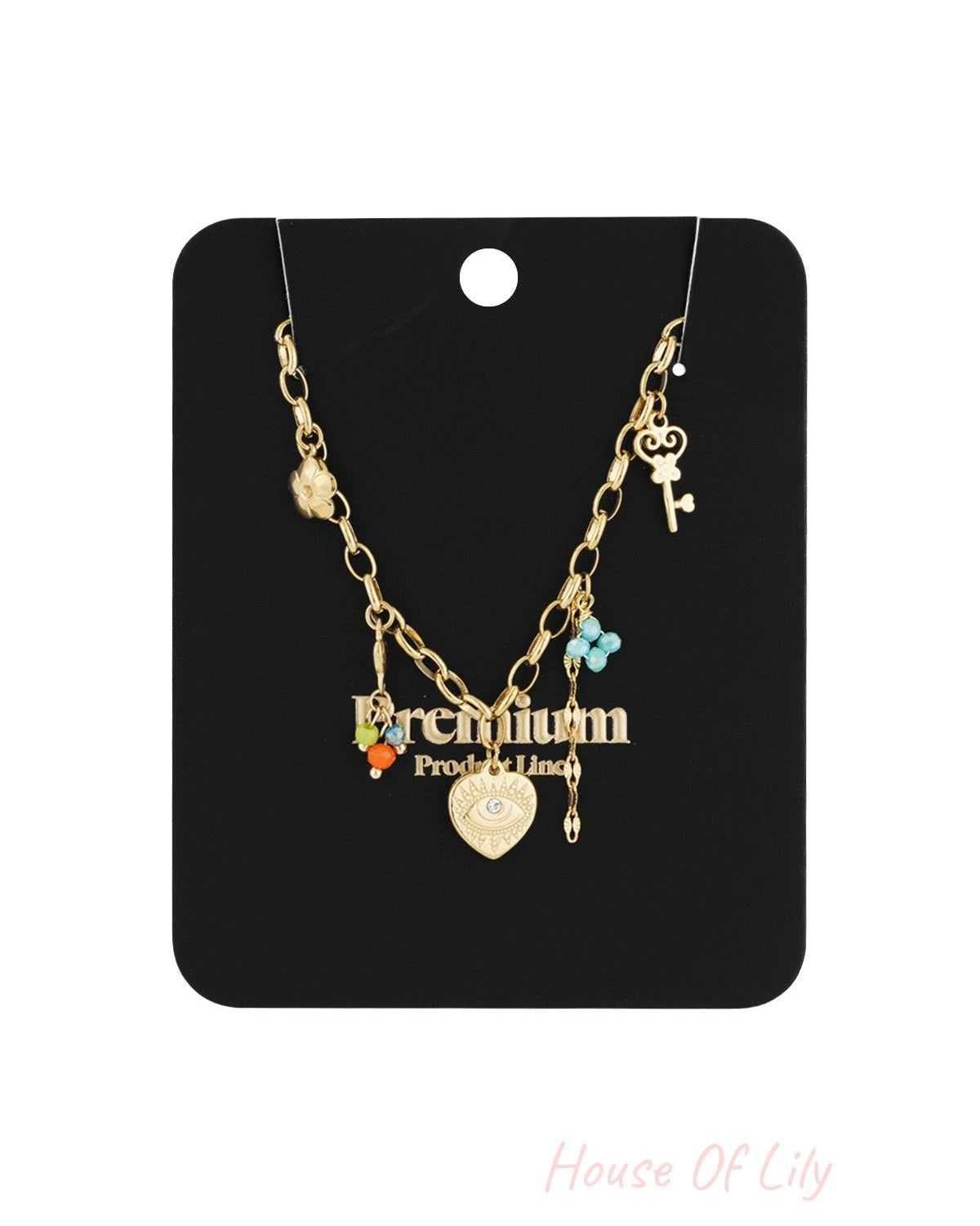 Golden charm link necklace displayed on black jewellery card with assorted pendants and colourful bead details