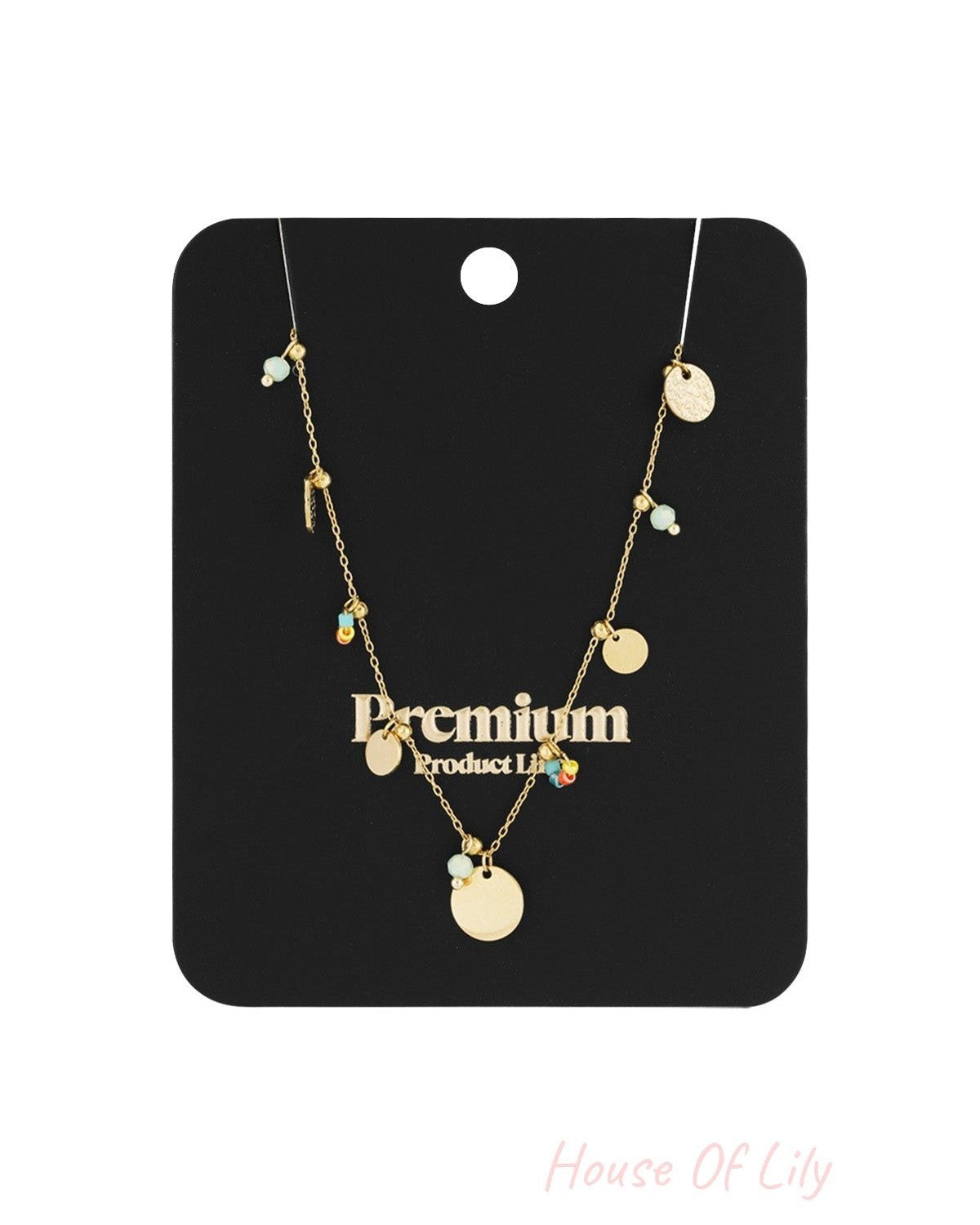 Gold disc charm necklace displayed on black premium product card with gold discs and colourful bead details