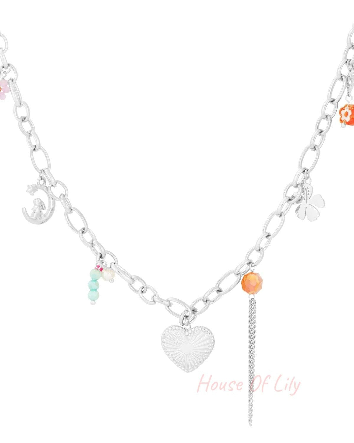 Silver variant of charm chain necklace with heart pendant, clover, crescent moon charms and colourful beads on white background