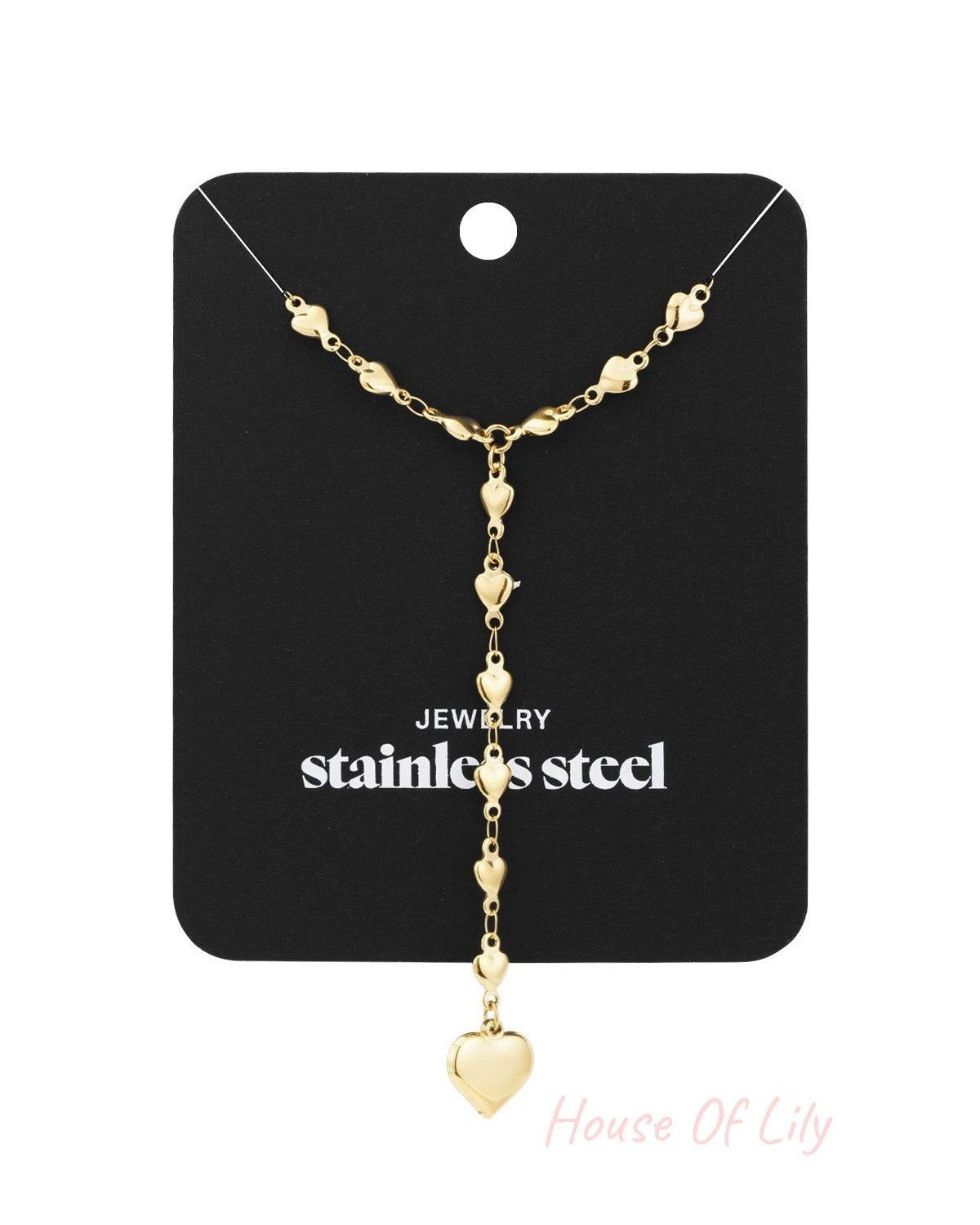 Gold heart chain necklace displayed on black stainless steel jewellery card