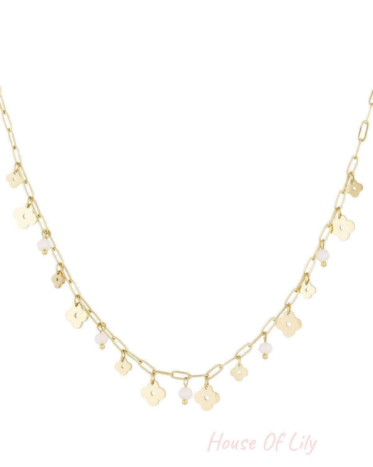 Gold-tone delicate charm necklace featuring clover charms and white bead accents on a white background