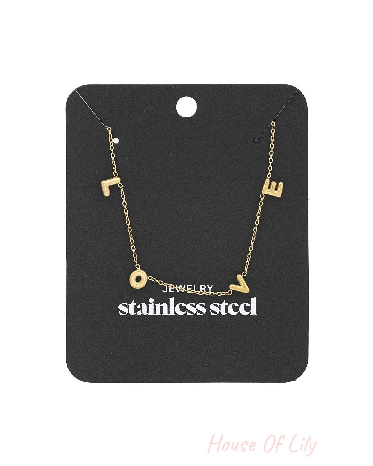 Gold LOVE necklace displayed on black packaging card labelled stainless steel