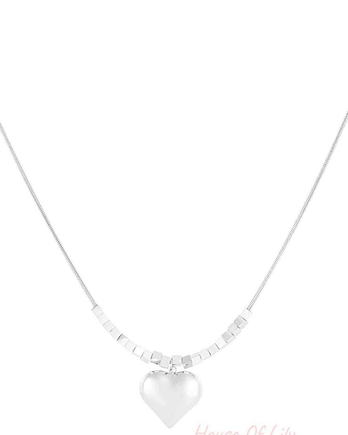Silver chunky heart pendant necklace with cube bead chain on white background