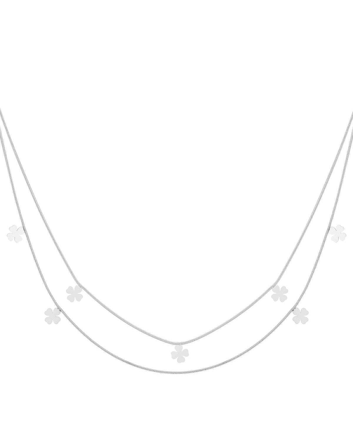 Double-layer silver necklace featuring multiple small four-leaf clover charms on delicate chains laid flat