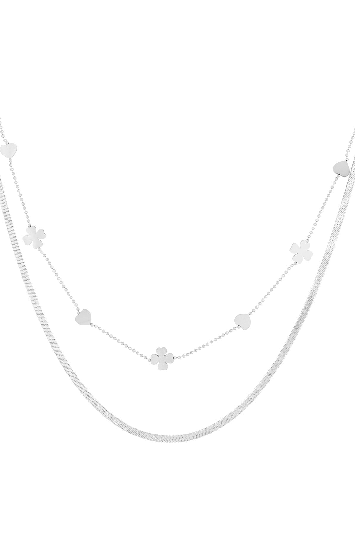 Close-up of silver double-layered necklace with heart and four-leaf clover charms on white background