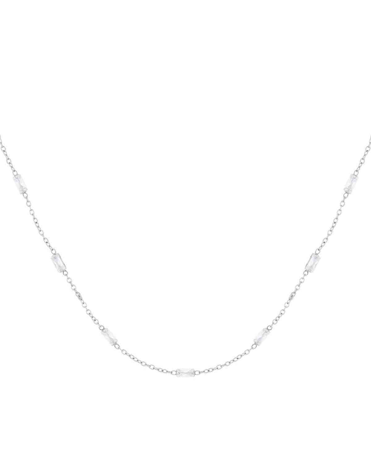Silver tone delicate chain necklace with rectangular clear crystals spaced evenly along the chain on white background
