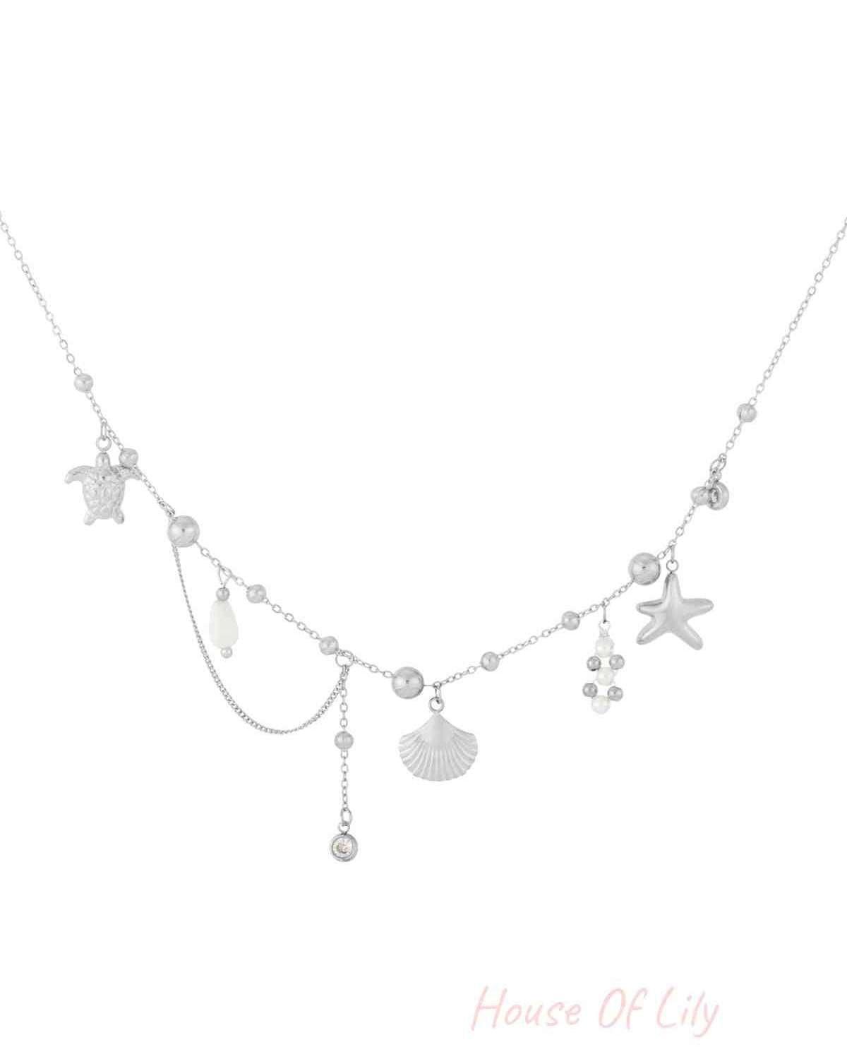 Azure Vibe silver chain necklace featuring dangling charms: sea turtle, seashell, starfish, and pearl accents.