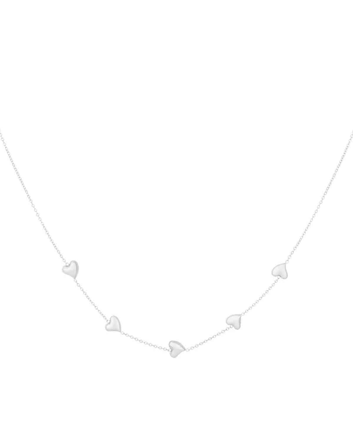 Silver dainty necklace with five small heart-shaped charms evenly spaced on a fine chain, isolated on white background
