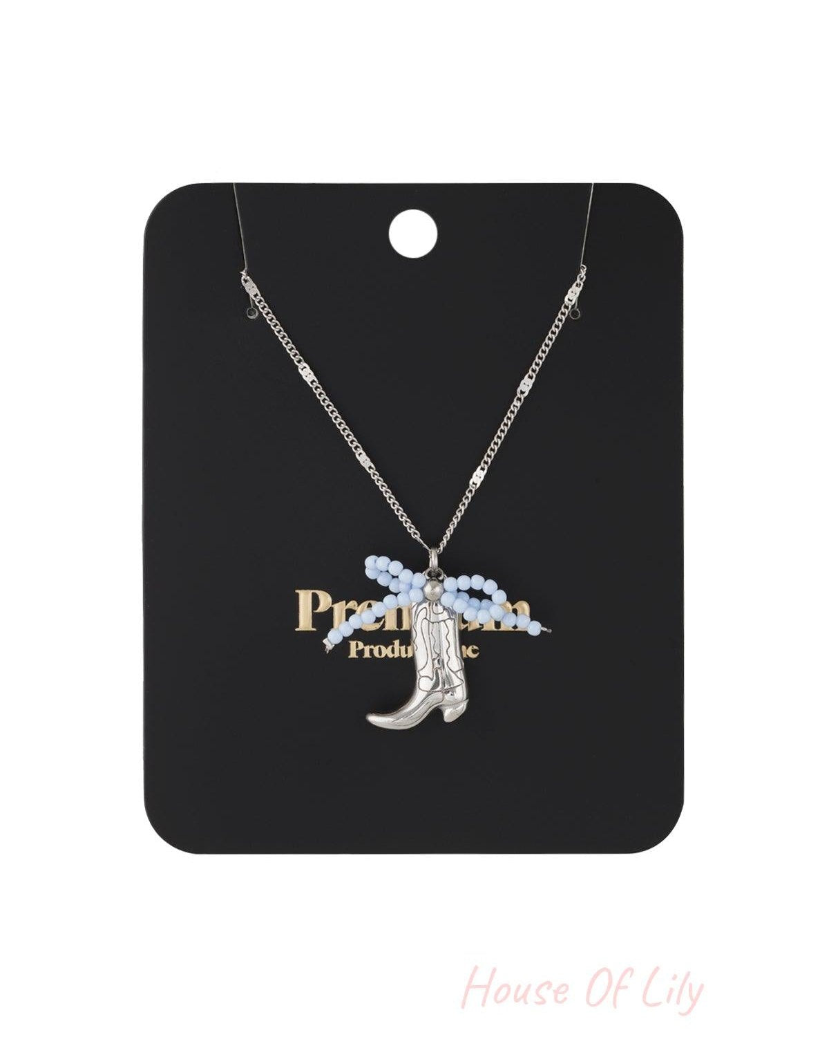 Gold-tone cowboy boot pendant necklace with vibrant pink and orange beaded bow on fine chain