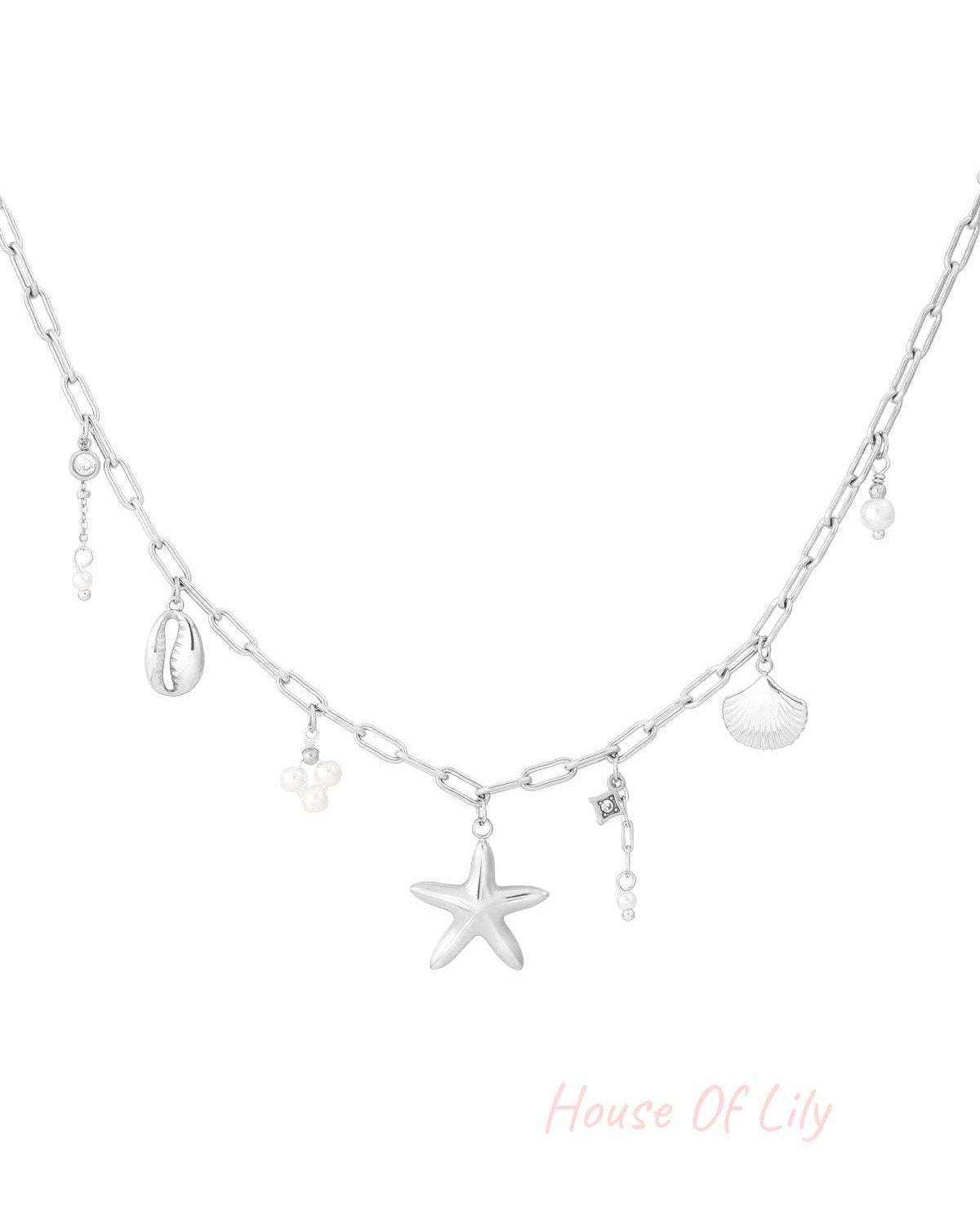 Silver charm necklace with starfish and shell charms on white background