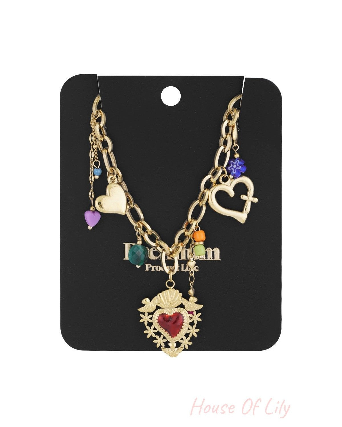 Gold charm necklace displayed on a black jewellery card showcasing the mix of heart pendants and colourful beads