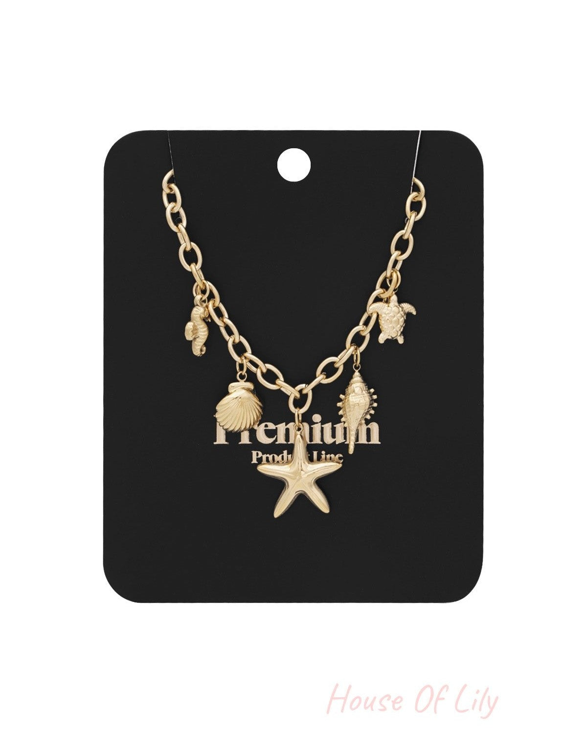Gold-tone ocean charm necklace displayed on black premium product card