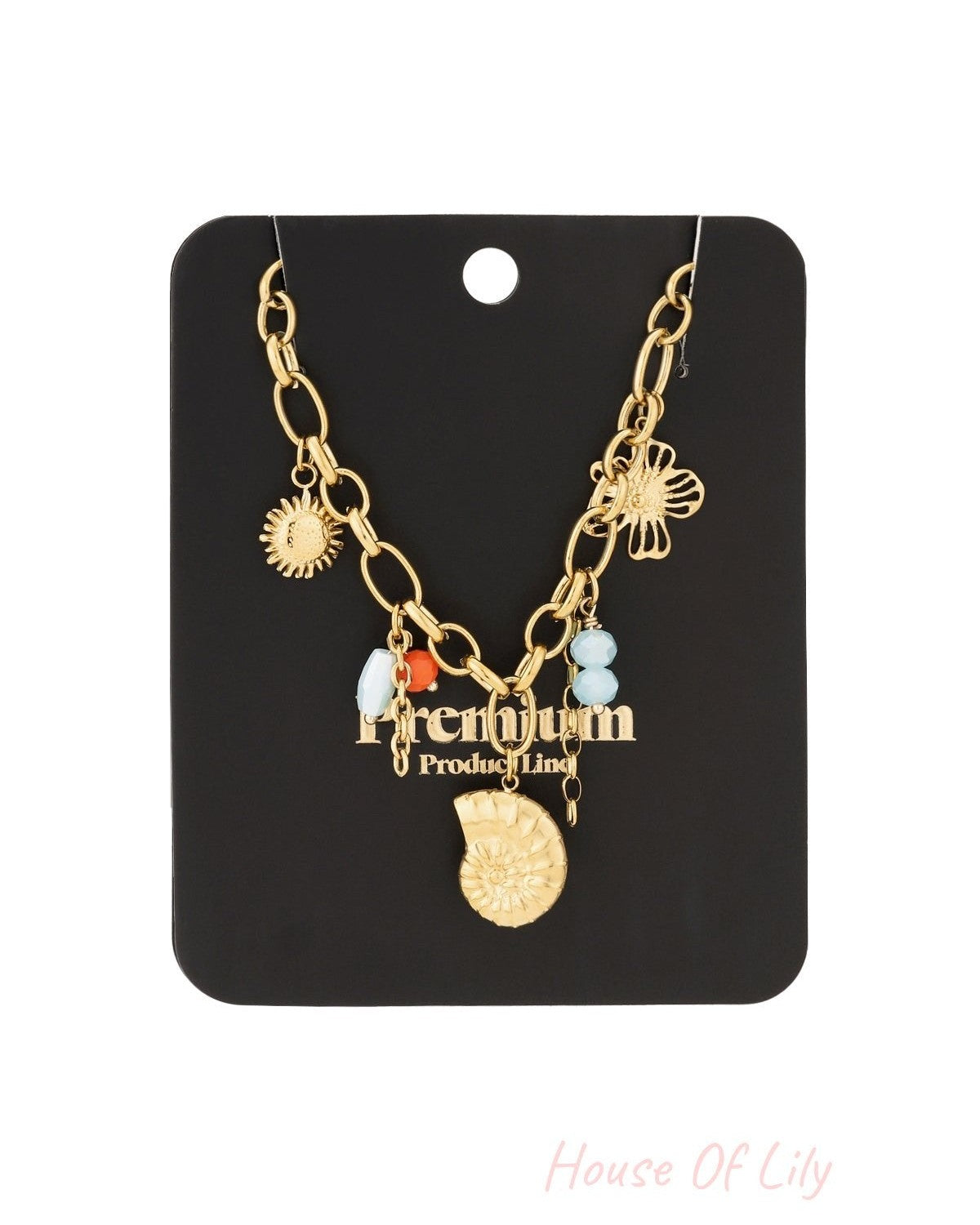 Gold charm link necklace displayed on black boutique-style card