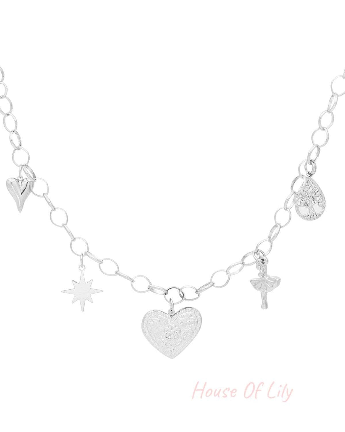 Silver-tone version of the charm necklace with heart, star, ballerina, tree, and embossed heart pendants on a white background