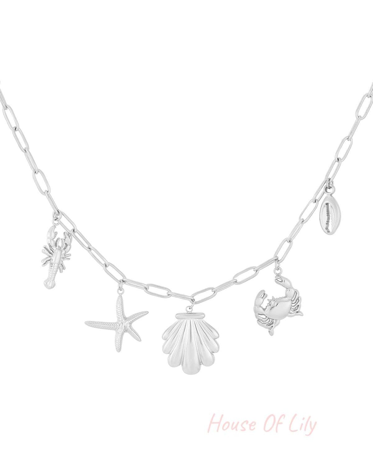 Silver chain necklace with seaside-themed charms including lobster, starfish, scallop shell, crab, and cowrie shell on white background