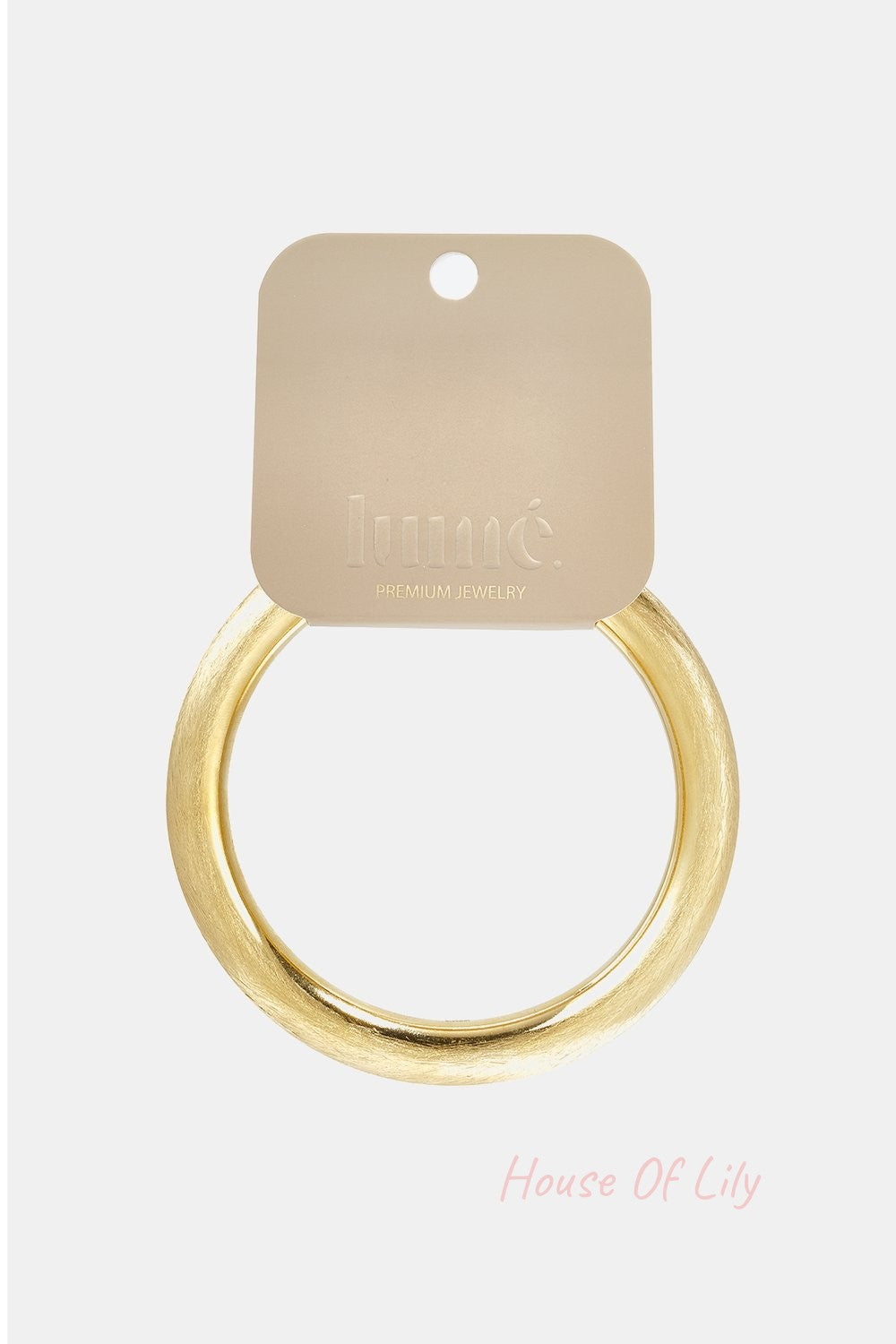 Minimalist round gold bangle with a brushed matte finish on a branded Lumé jewelry display card.
