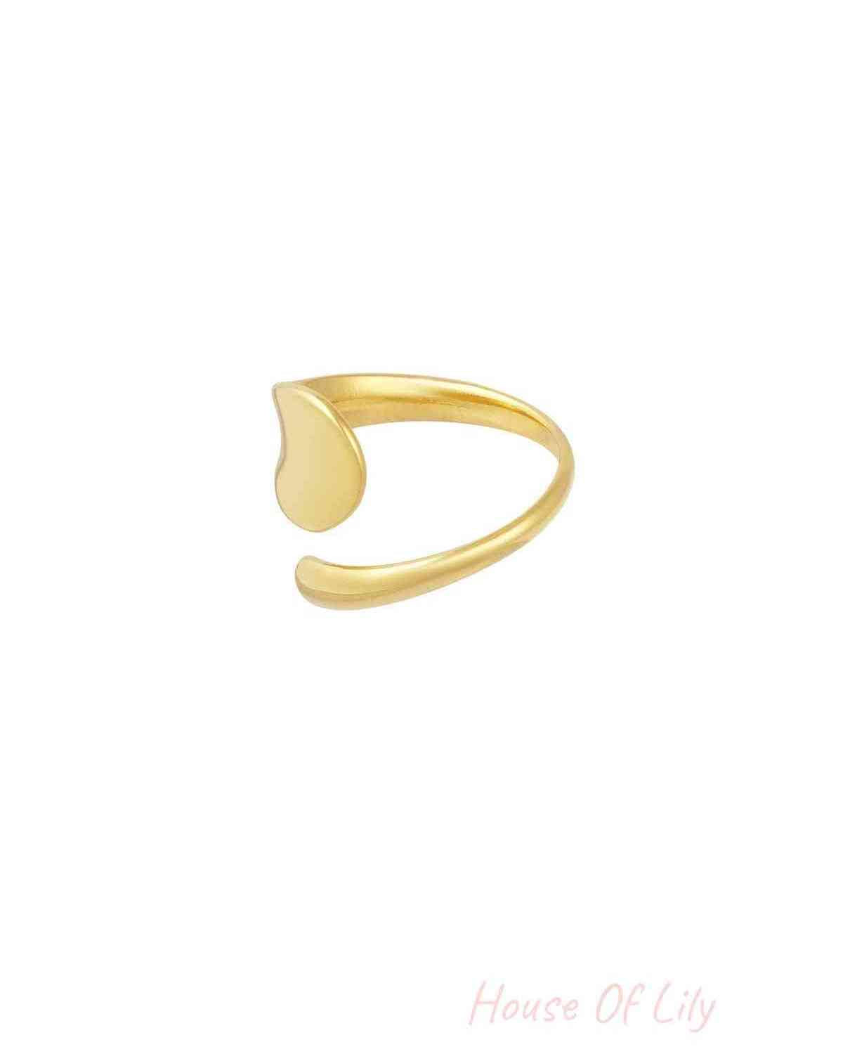 Gold minimalist ring shown from a side angle highlighting the adjustable open band and smooth finish