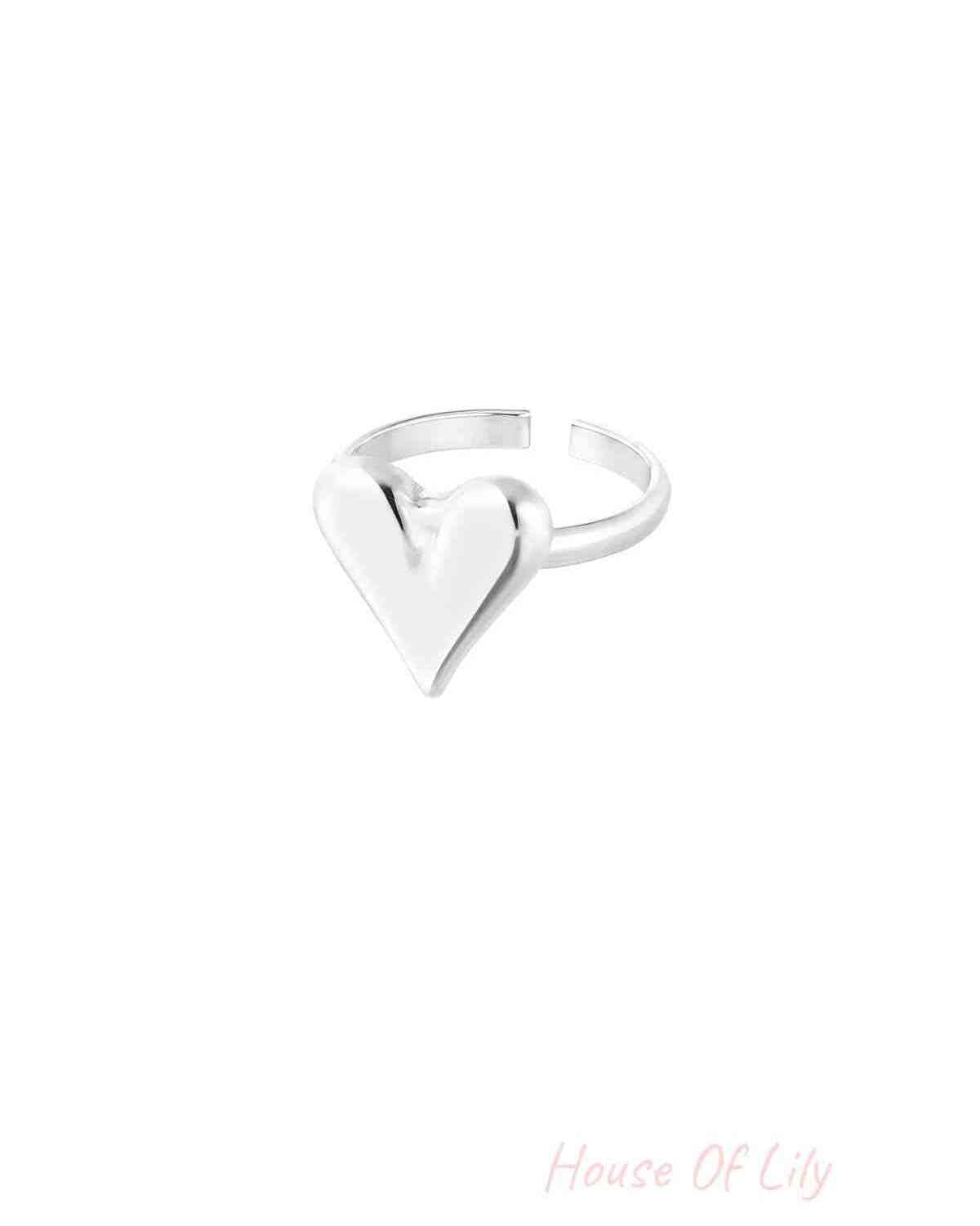 Silver adjustable ring with the same shiny puffy heart design isolated on white background