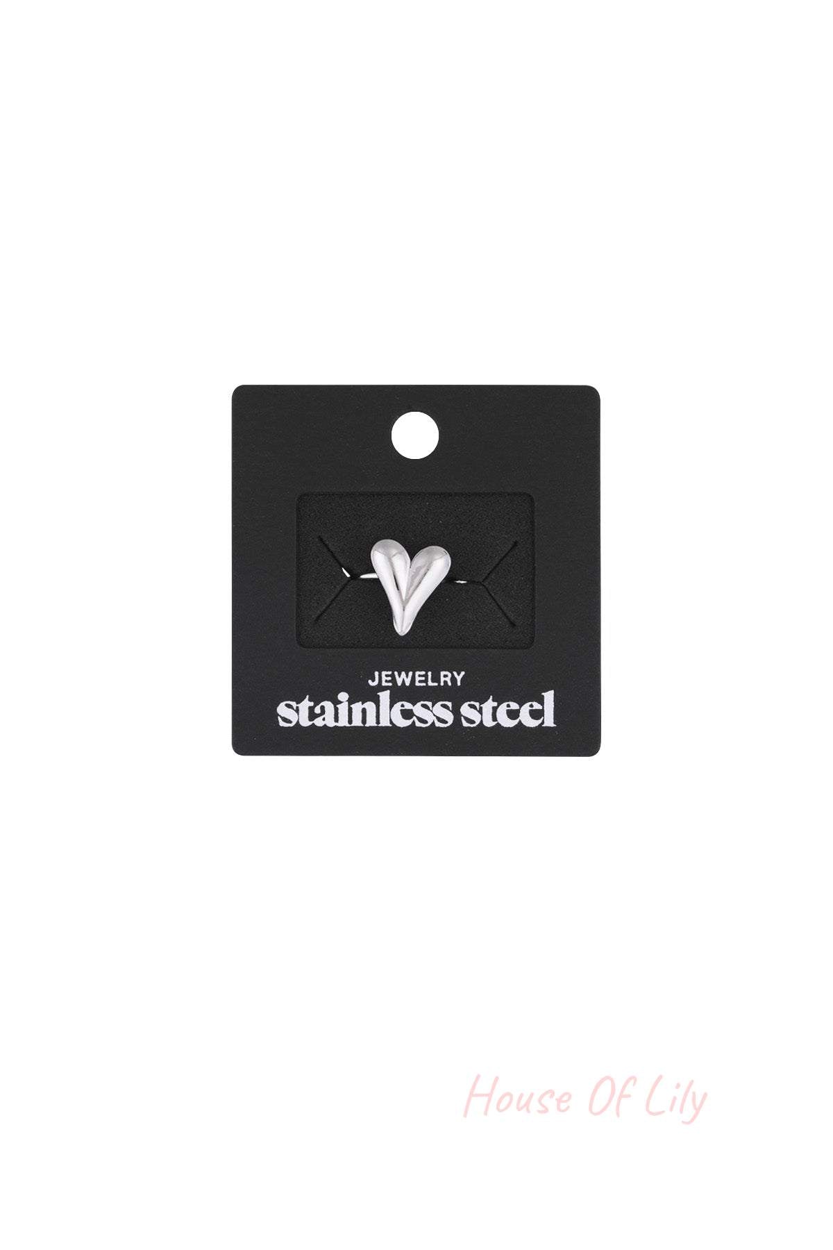 Silver heart statement ring displayed on black packaging card labeled stainless steel jewelry