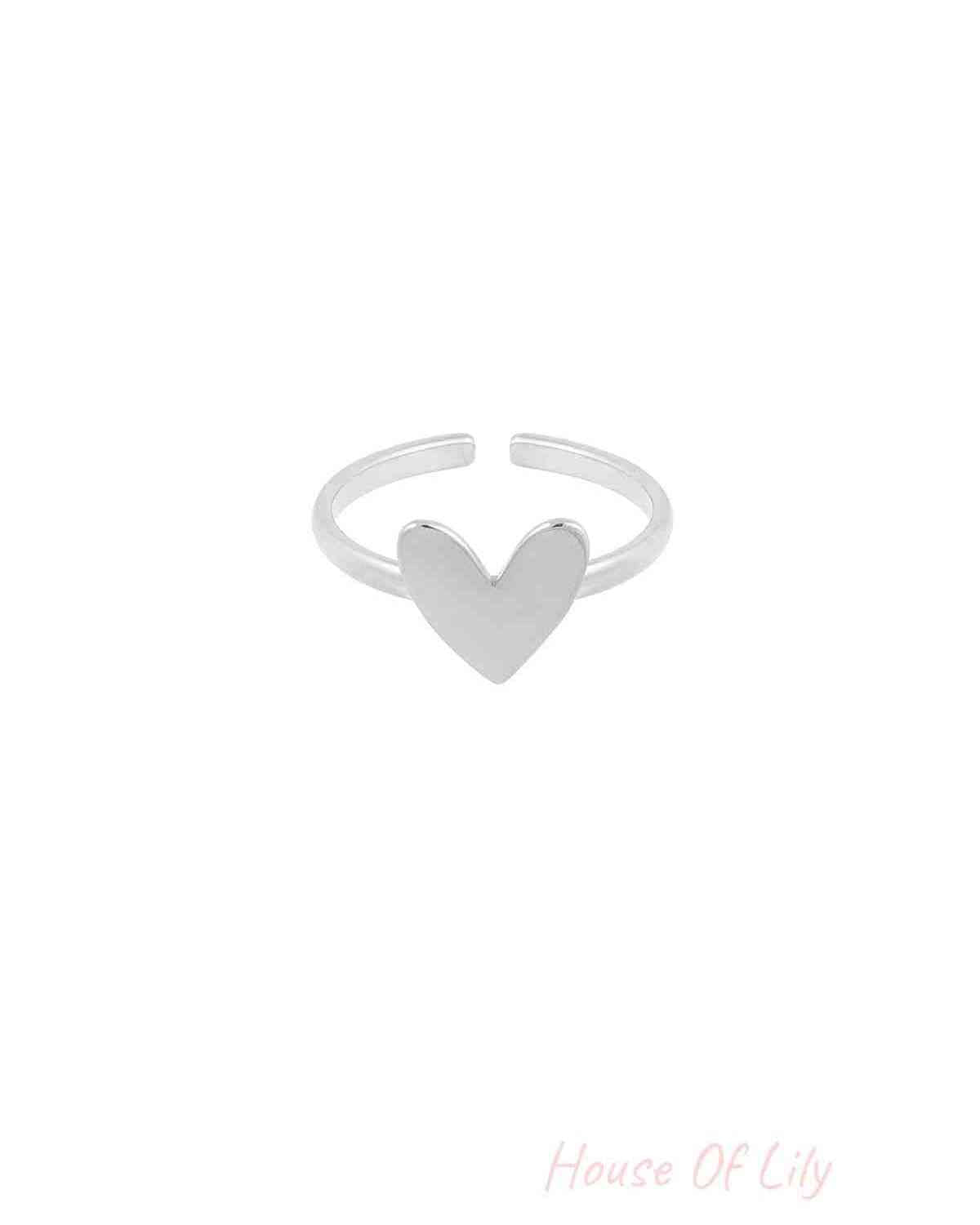 Silver-tone minimalist adjustable ring with smooth heart centerpiece on white background