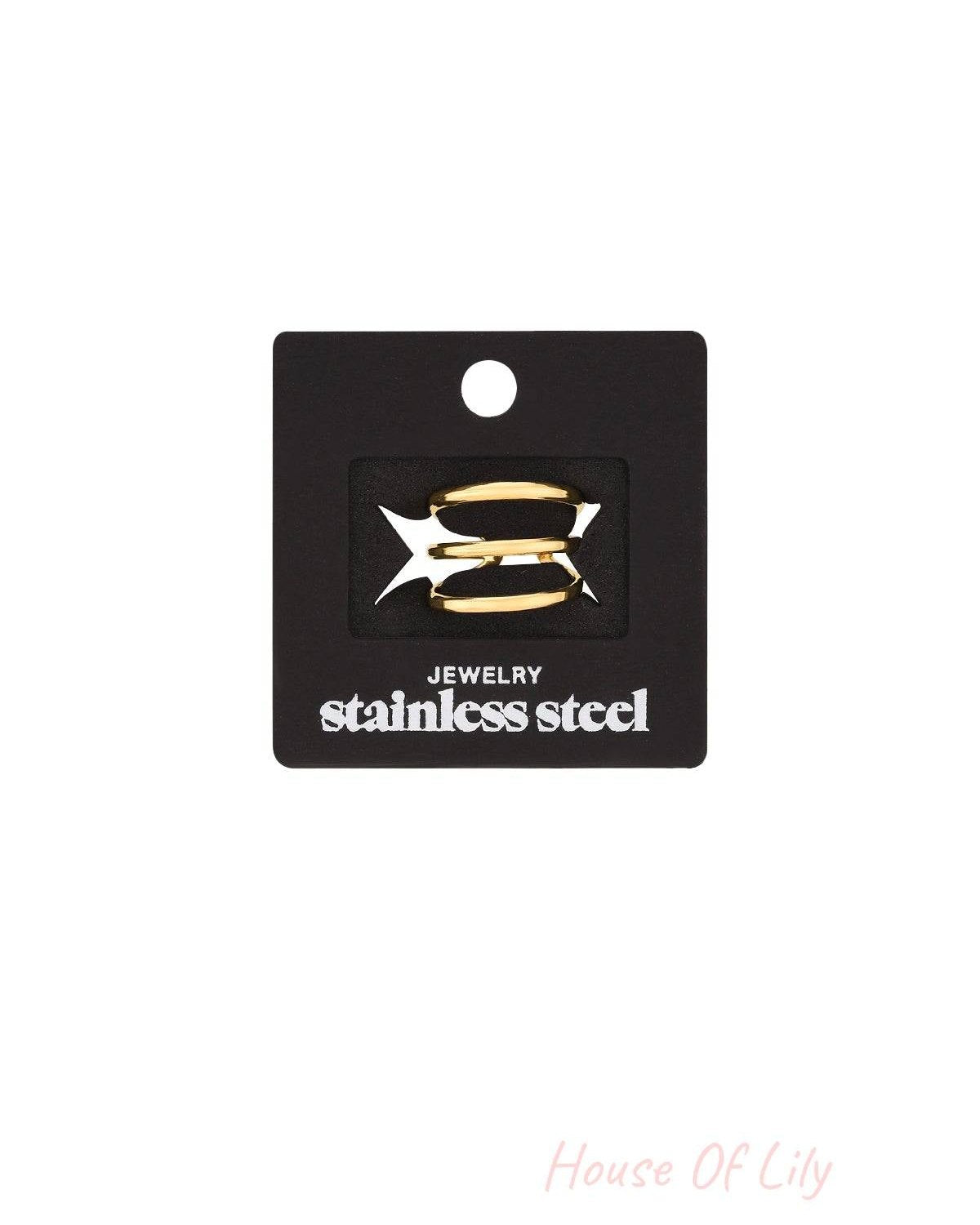 Gold three-layer ring displayed on black stainless steel jewelry card