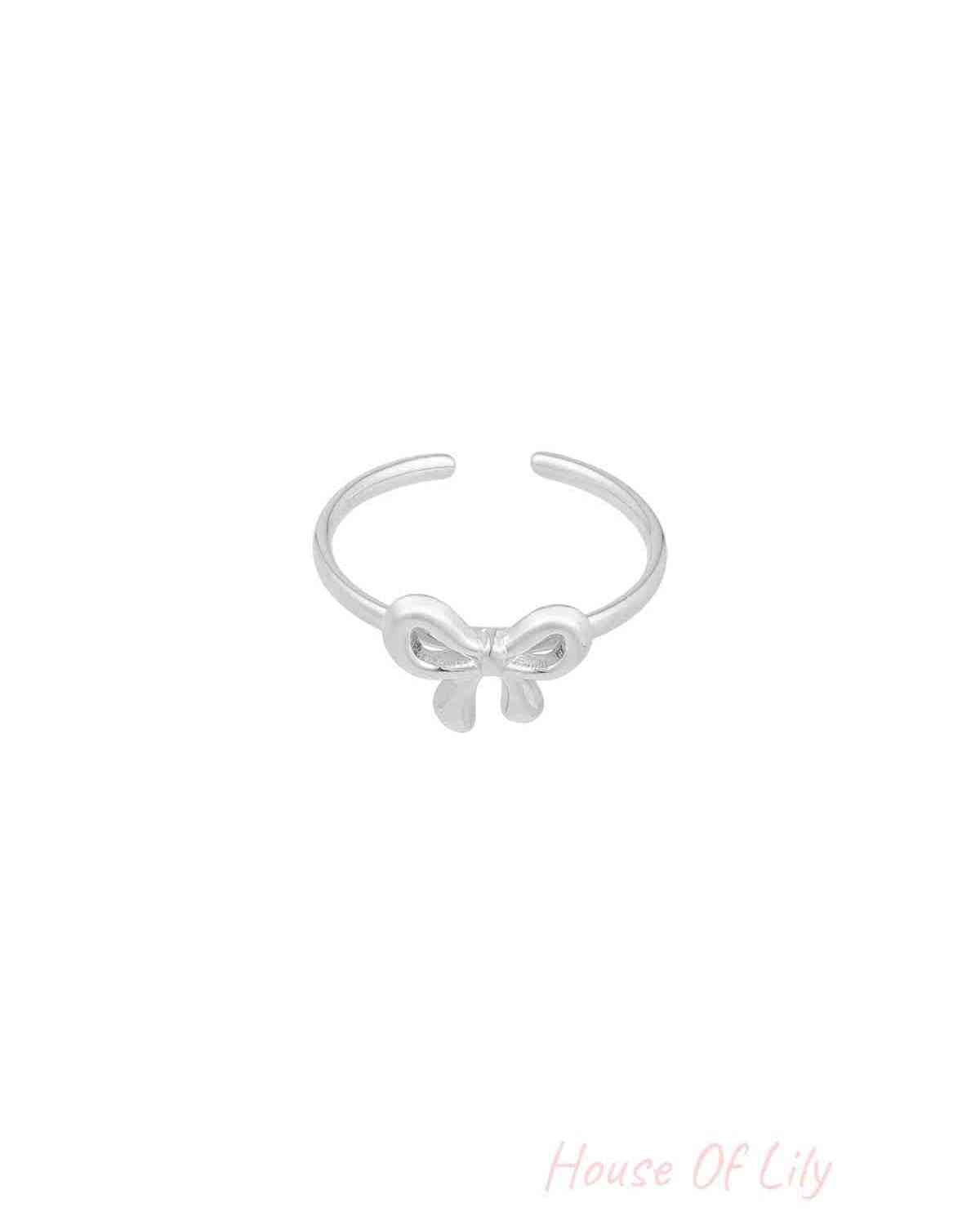 Silver minimalist open bow ring on white background