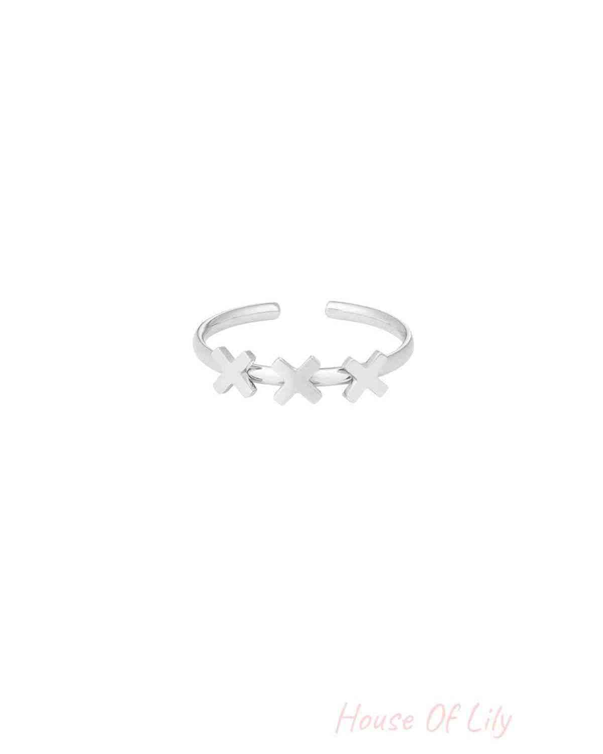 Silver-tone adjustable ring with three cross shapes on a white background