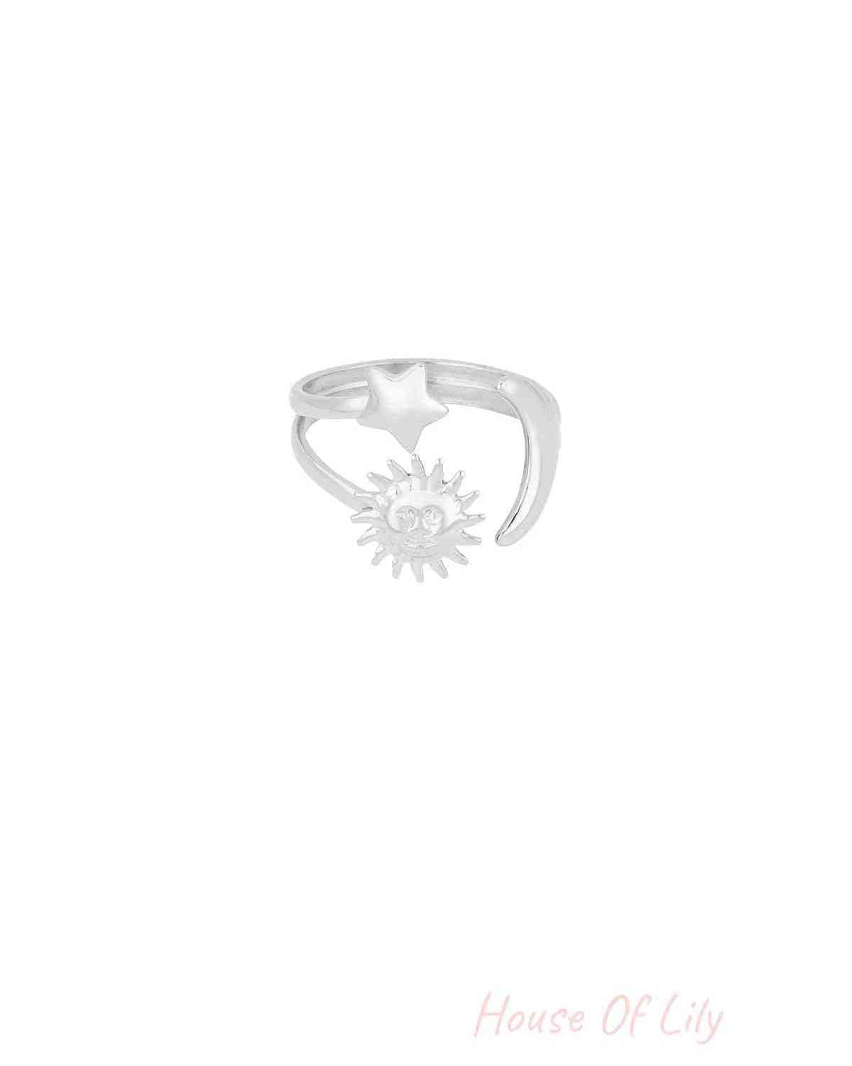 Silver finish celestial ring featuring star, crescent moon, and smiling sun motifs on white background