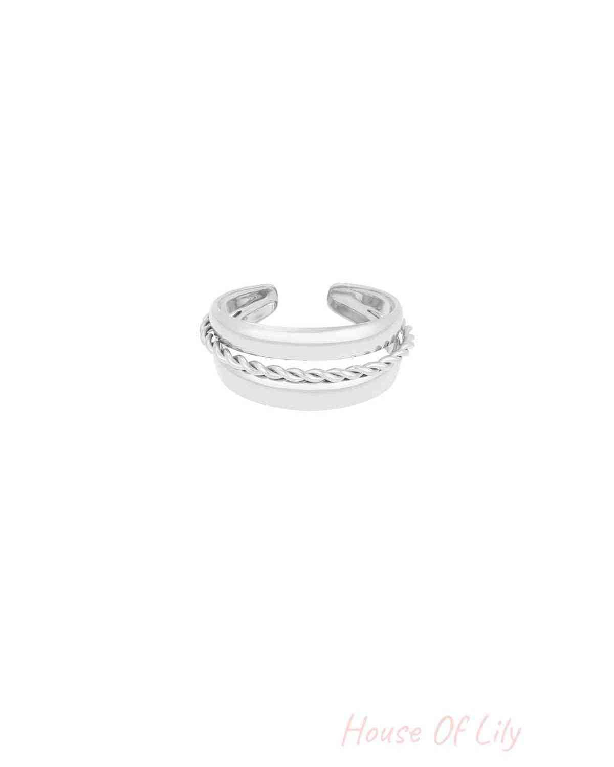 Silver stainless steel layered spiral ring isolated on white background, open-ended design