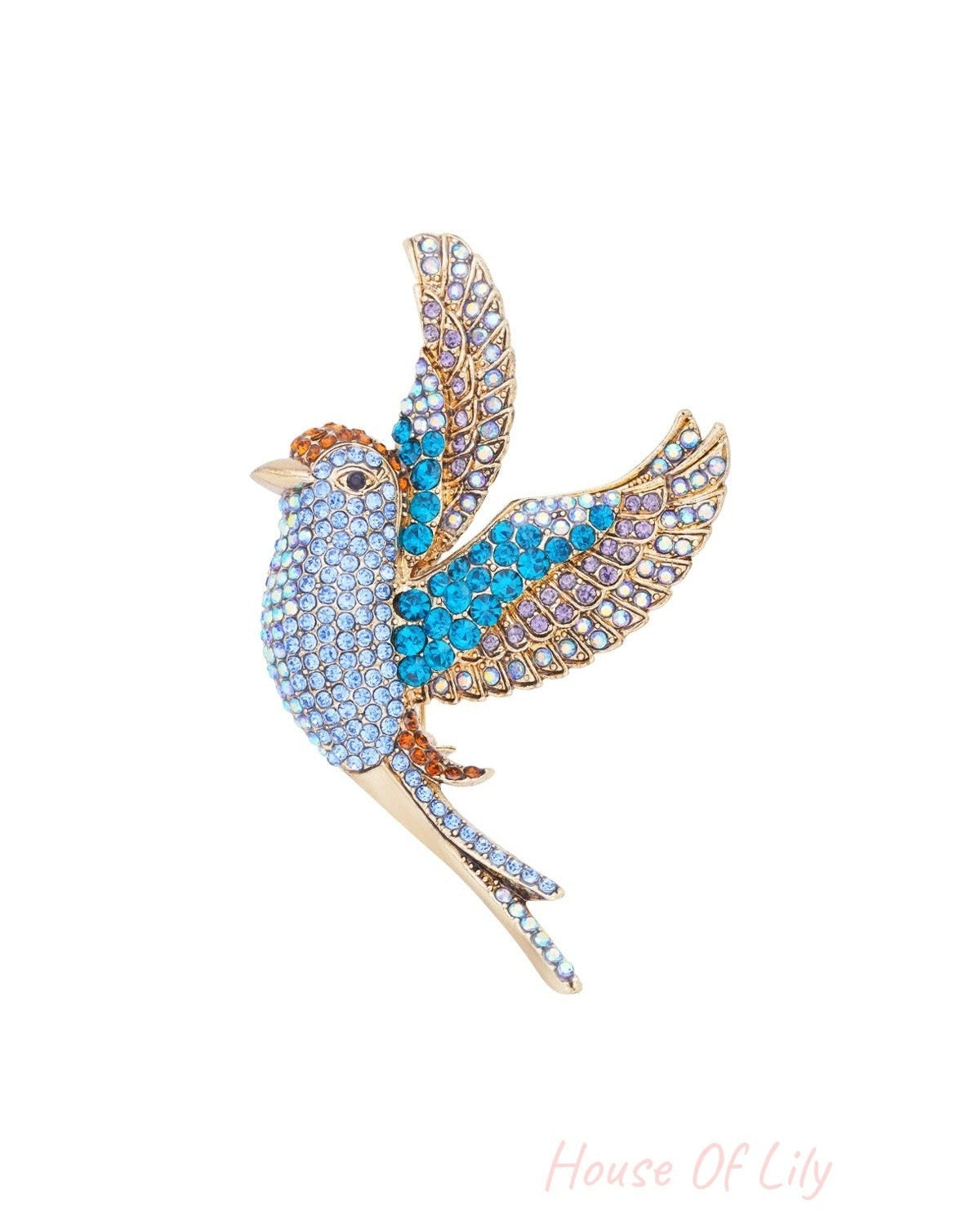 Close-up of sparkling bird brooch with blue, purple, and orange rhinestones on alloy base