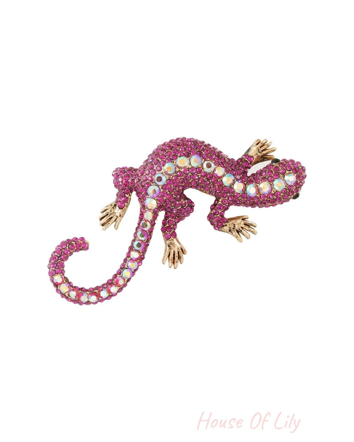 Close-up of magenta and iridescent crystal gecko brooch on white background