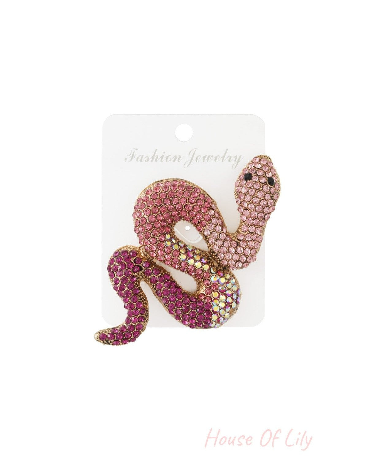 Pink and purple crystal snake brooch attached to white card labeled Fashion Jewelry