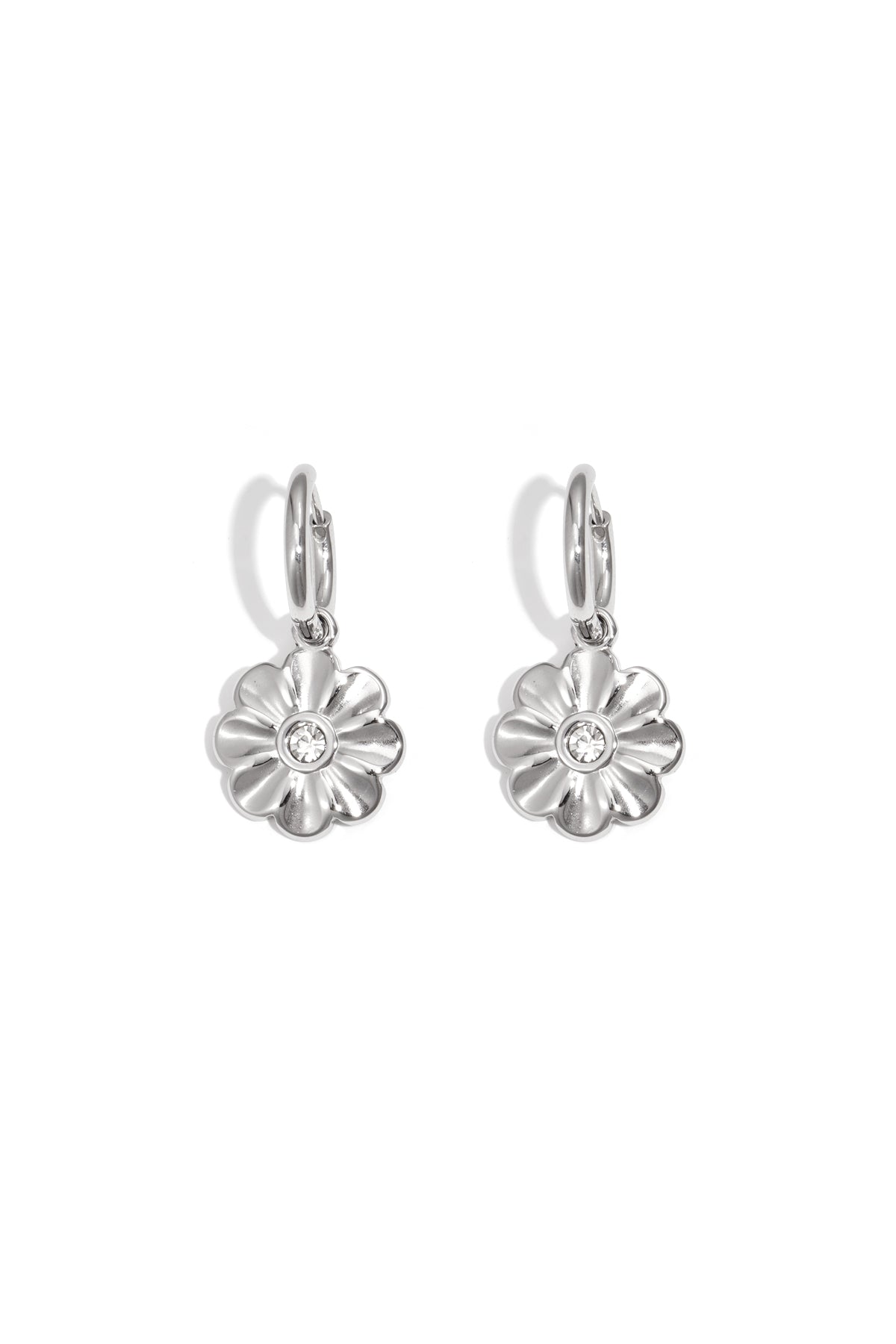 Pair of silver-tone floral charm hoop earrings with clear central stones on white background