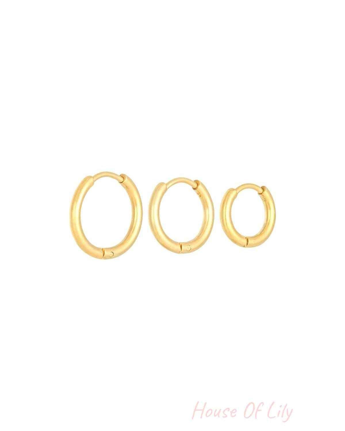 Set of three gold stainless steel hoop earrings in small, medium, and large sizes displayed against a white background